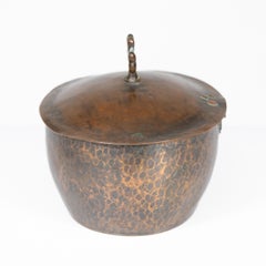 Hugh Wallis. An Arts and Crafts hand hammered copper pot and lid