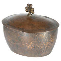 Hugh Wallis. An Arts and Crafts hand hammered copper pot and lid