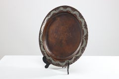 Hugh Wallis. An Arts & Crafts hand formed round copper plate