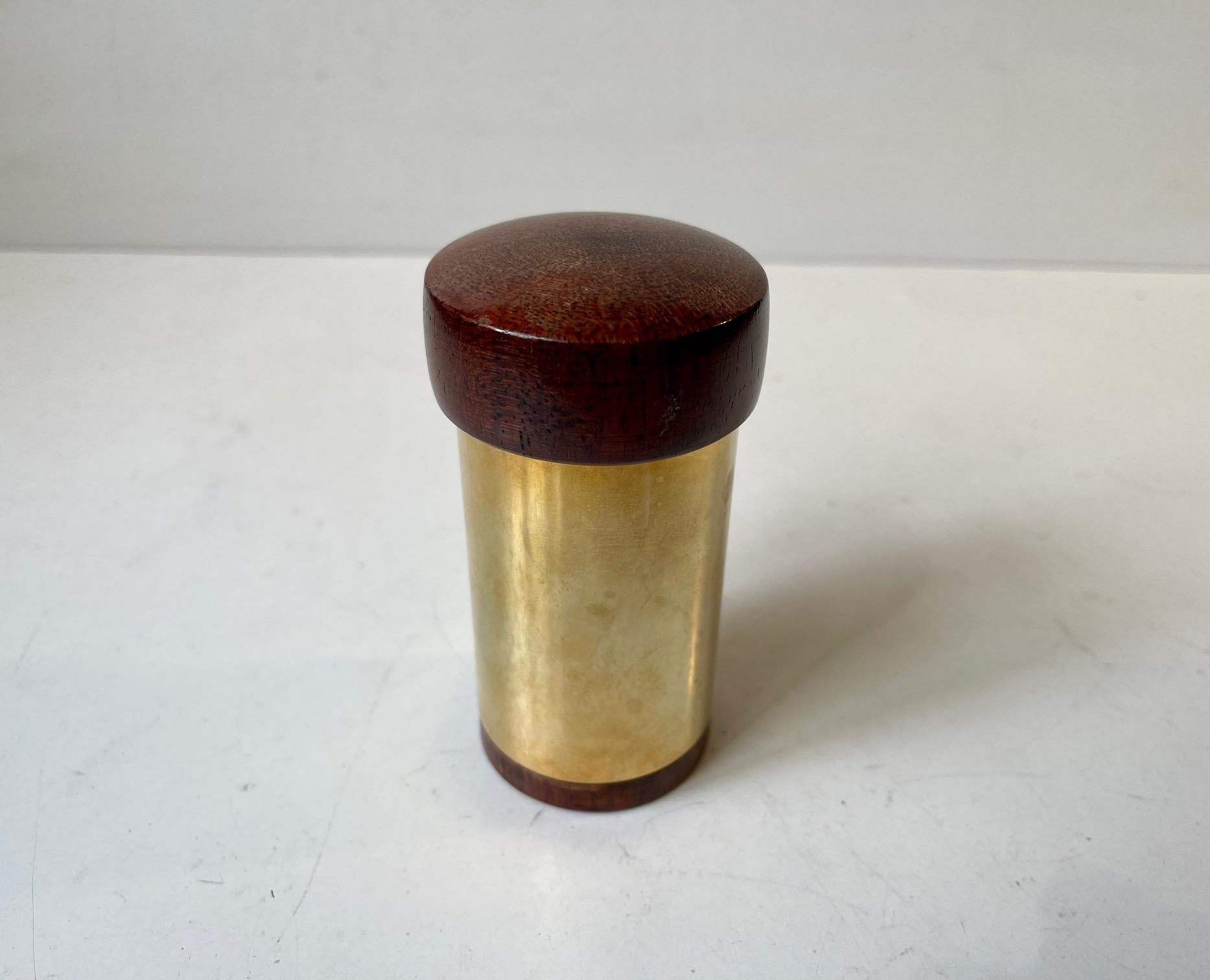 A rare beautifully crafted trinket jar, container for tea light candles or cotton swabs designed by Hugo Asmussen in Denmark circa 1960-70. Its made from 24 carat gold plated brass and features a lid and bottom in mahogany. Measurements: H: 11, D: 5