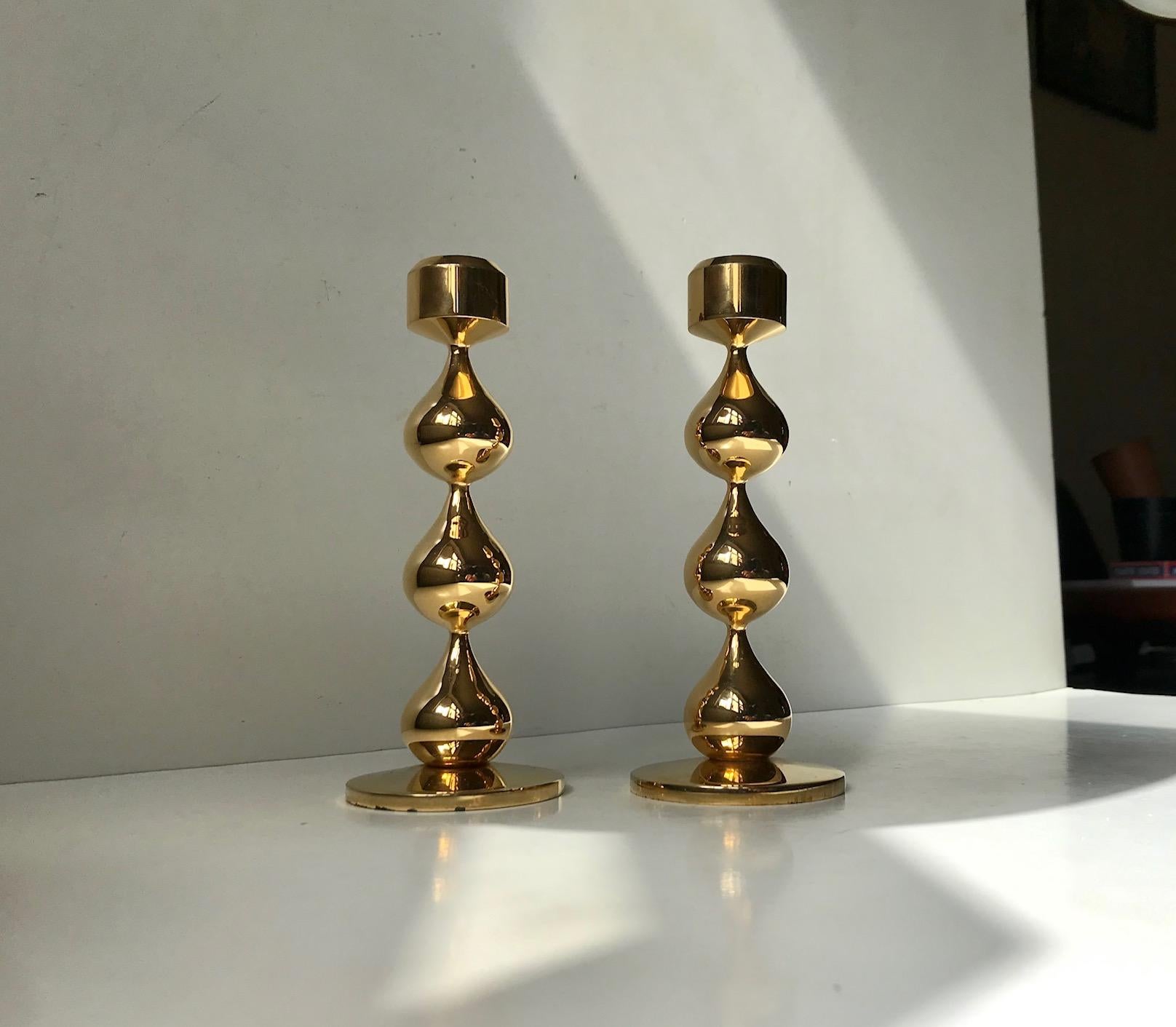 Large set of organically teardrop shaped 24-carat gold-plated candleholders was designed by Hugo Asmussen. This particular set were manufactured by Asmussen in Denmark in the 1970s. They are suited for regular sized candles. Measure: Height: 17 cm.