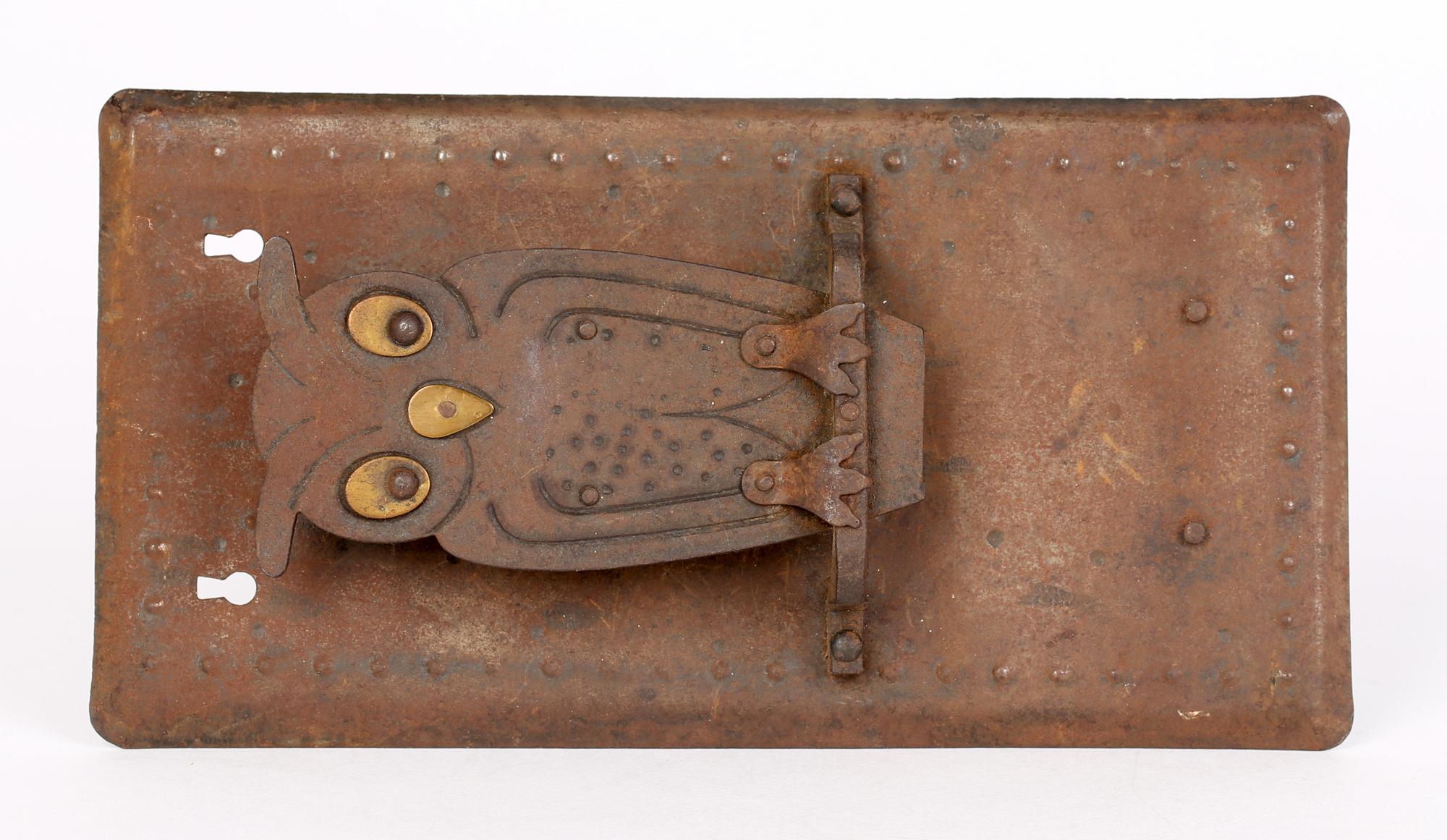 A very stylish German Jugendstil iron industrial style owl wall hanging match box holder designed by Hugo Berger for Goberg and dating from around 1910. This heavily made sheet metal wall hanging match box holder is modelled as an owl sitting on a