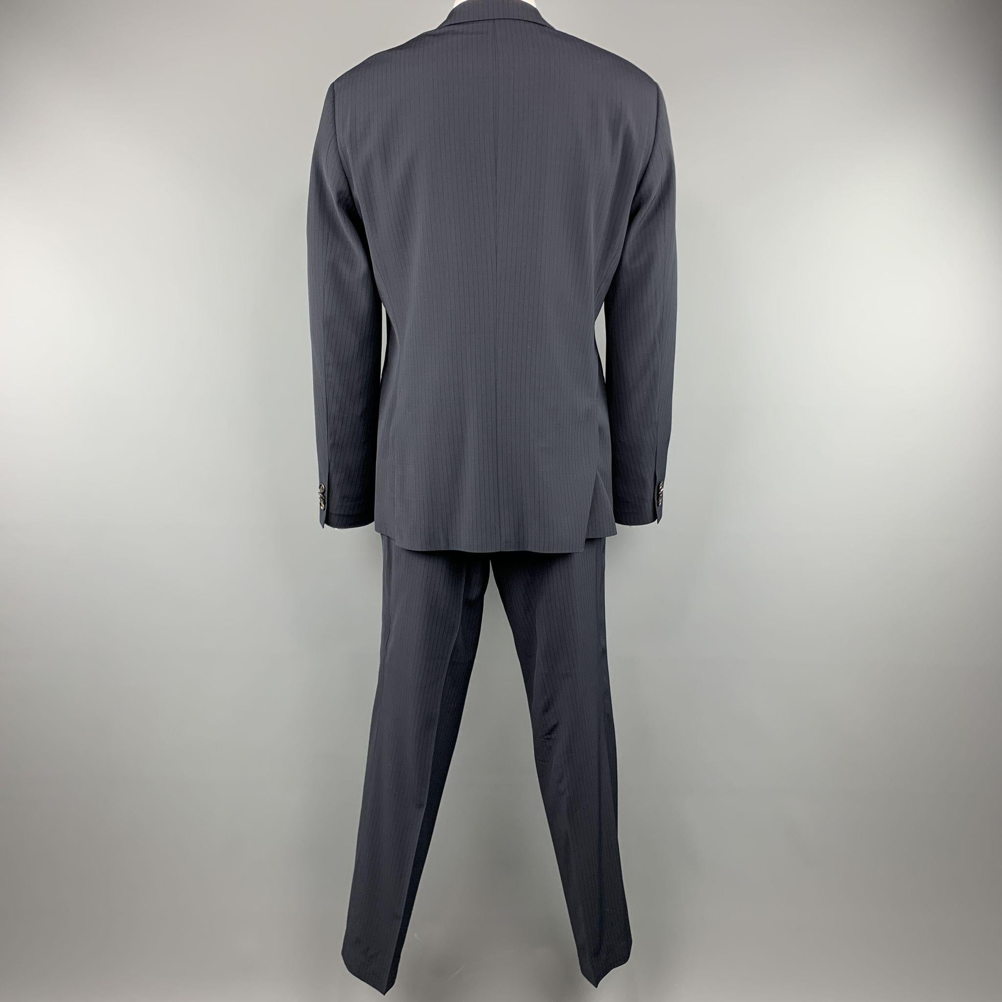 HUGO BOSS suit comes in a navy stripe wool / elastane and includes a single breasted, two button sport coat with notch lapel and matching front trousers.

Excellent Pre-Owned Condition.
Marked: 44 R

Measurements:

-Jacket
l Shoulder: 20.5 in.
l