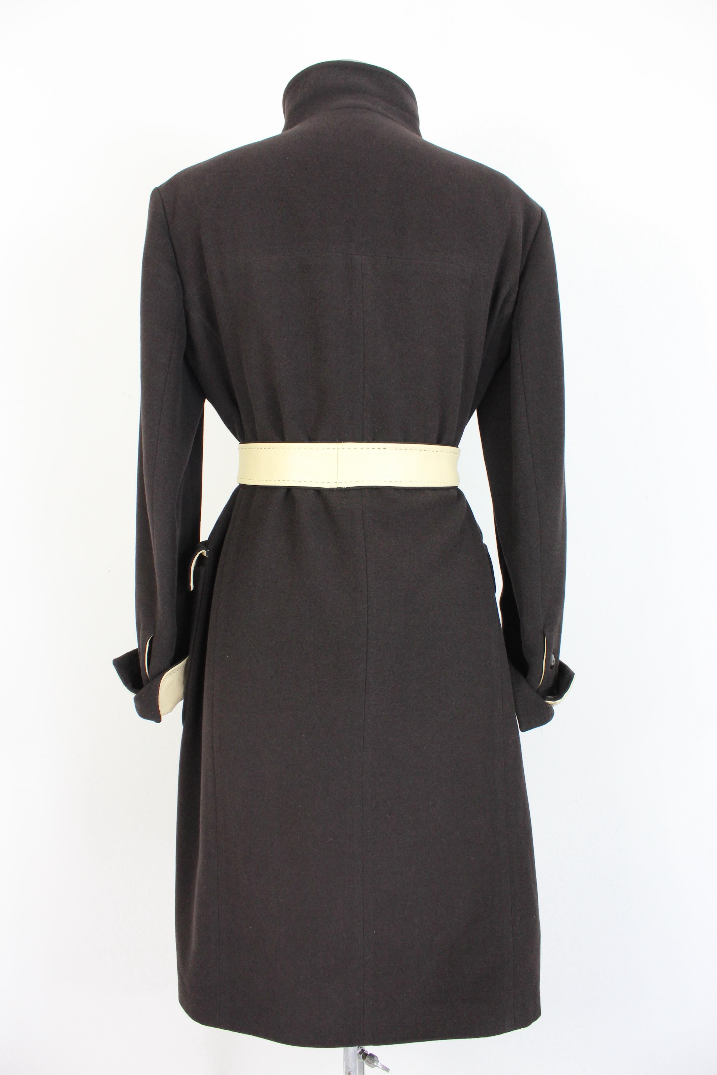 Hugo Boss vintage 2000s women's coat. Long, classic coat, black color and beige leather inserts. There is the possibility of closing the high collar, belt at the waist. Fabric 32% angora, 32% wool, 36% cashgora, internally lined 100% cupro. Made in