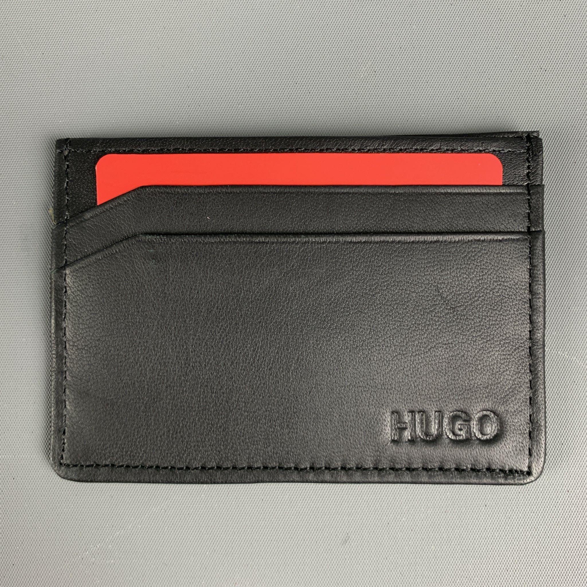 HUGO BOSS card holder case wallet comes in black smooth leather. Comes with Box.Excellent Pre-Owned Condition.4 x 3 inches 
  
  
 
Reference No.: 128073
Category: Wallet
More Details
    
Brand:  HUGO BOSS
Color:  Black
Type of Leather: 