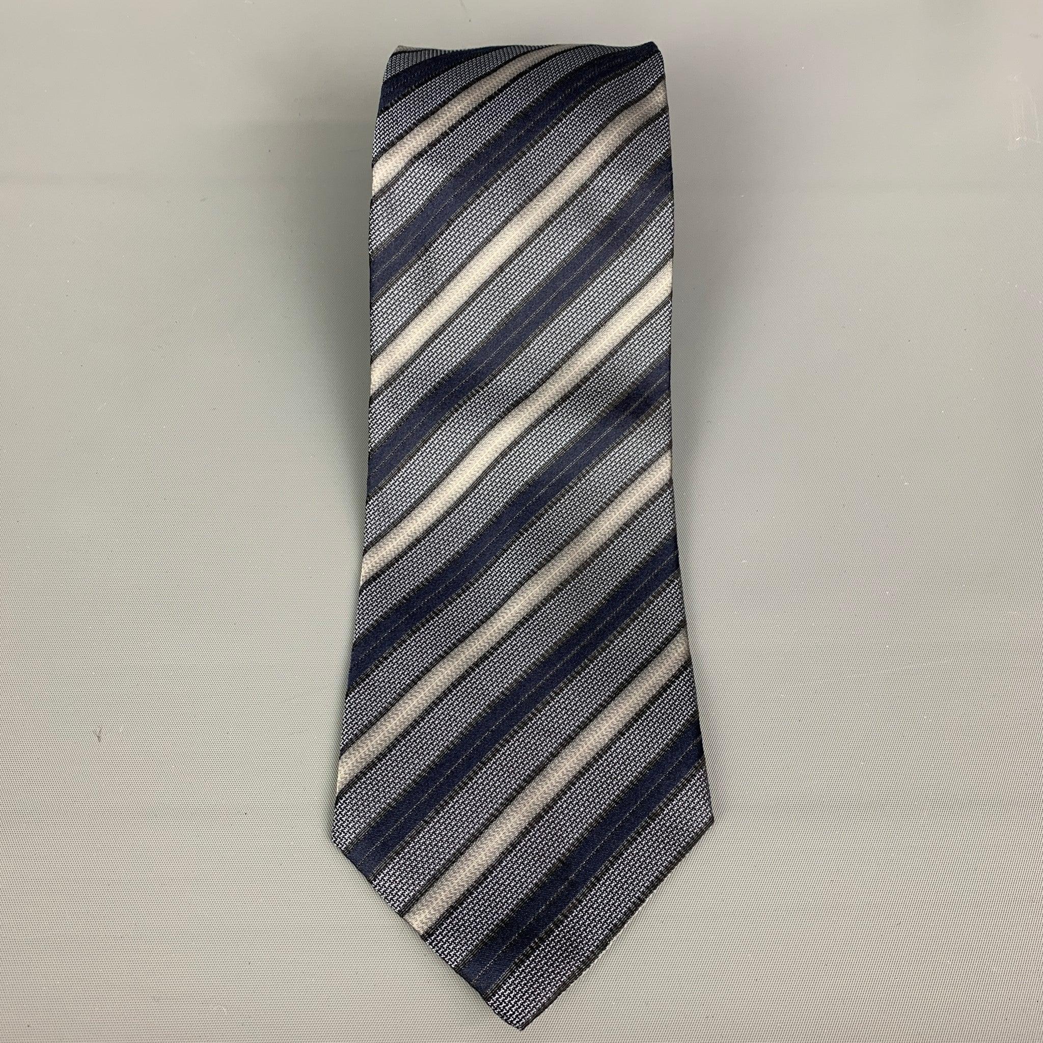 HUGO BOSS necktie comes in charcoal, black and blue stripped silk material. Made in Italy.Very Good Pre-Owned Condition. Minor sign of wear.Width: 4 inches Length: 61 inches 

  
  
Reference: 19856
Category: Tie
More Details
    
Brand:  HUGO