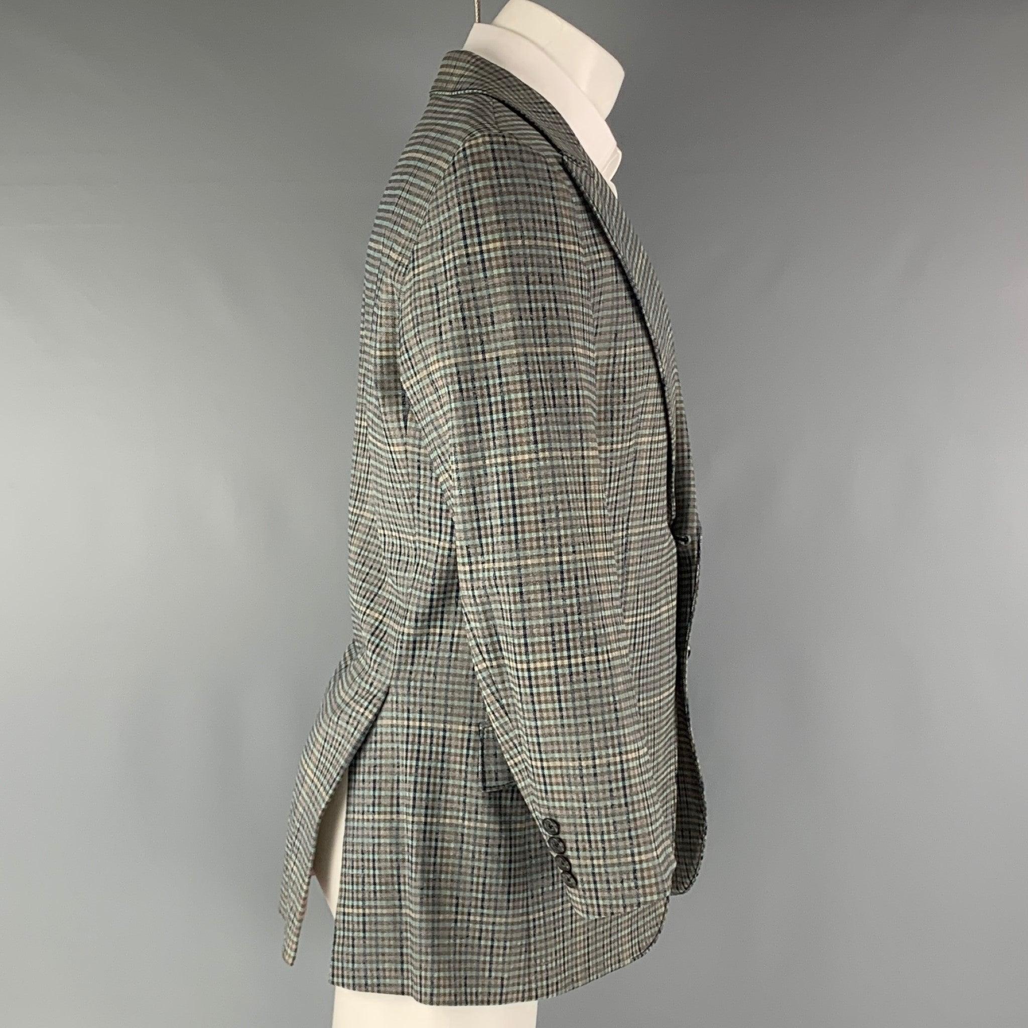 HUGO BOSS Sport Coat comes in a grey and navy plaid cotton elastane woven material, with a peak lapel, flap pockets, two buttons at closure, double vent at back and buttoned cuffs. Very Good Pre-Owned Condition. Minor mark at lining right side.