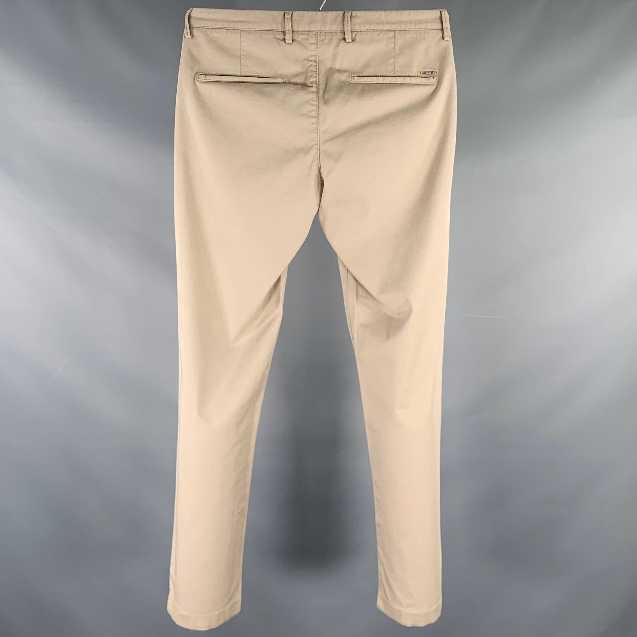 HUGO BOSS casual pants
in a beige cotton stretch blend fabric featuring a chino style, straight leg, and zip fly closure.Very Good Pre-Owned Condition. Minor signs of wear. 

Marked:   IT 46 

Measurements: 
  Waist: 30 inches Rise: 8.5 inches