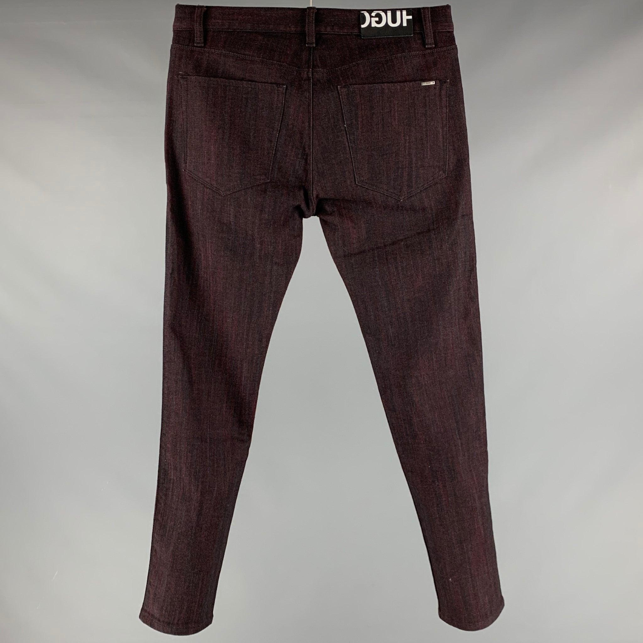 HUGO by HUGO BOSS jeans
in a black and burgundy cotton blend fabric featuring five pockets style, and zip fly closure.Excellent Pre-Owned Condition. 

Marked:   32/32 

Measurements: 
  Waist: 32 inches Rise: 8.5 inches Inseam: 32 inches 
  
  
