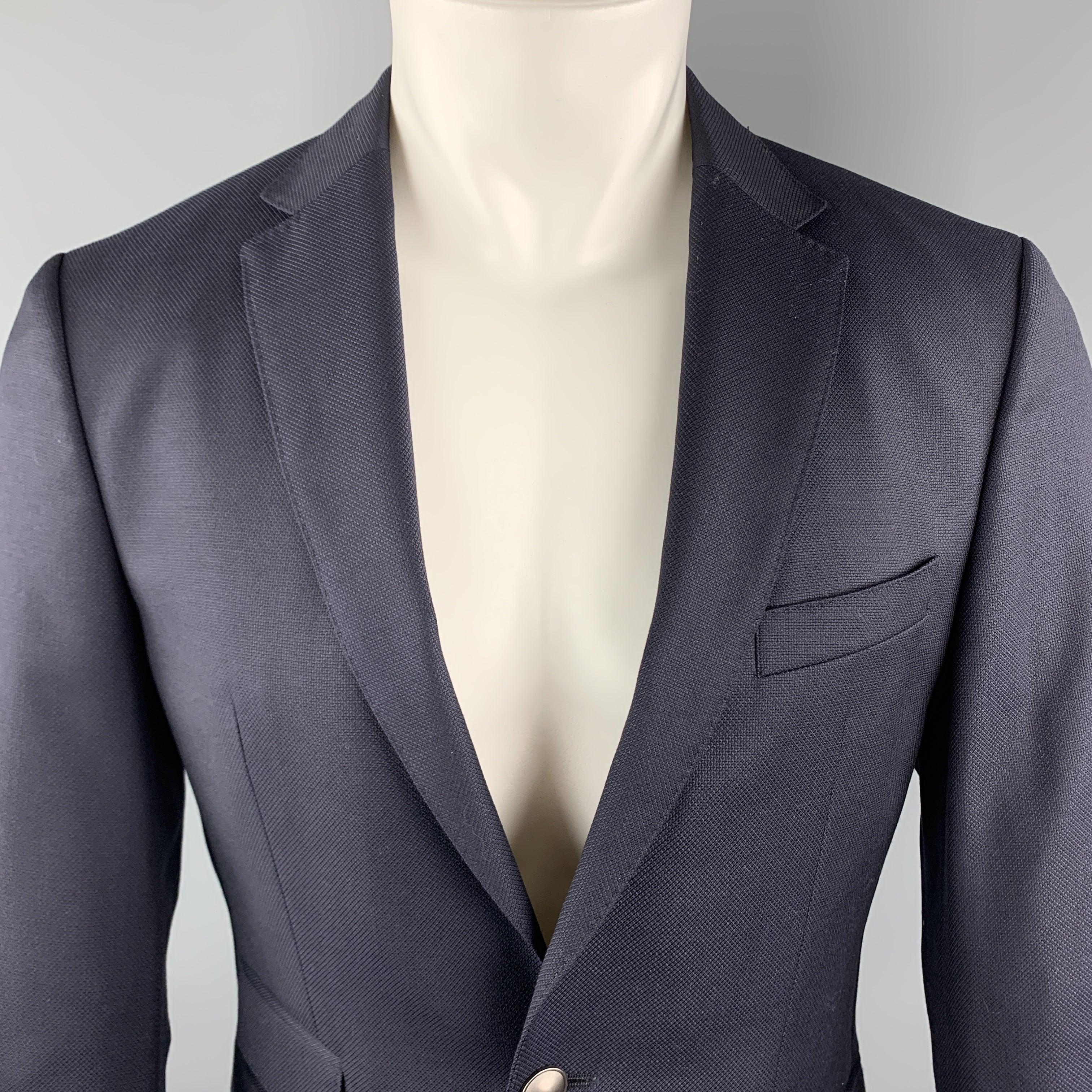 HUGO BOSS Sport Coat comes in a navy woven wool featuring a notch lapel style, flap pockets, and a two button closure.
Excellent
Pre-Owned Condition. 

Marked:   46 

Measurements: 
 
Shoulder: 17 inches 
Chest: 36 inches 
Sleeve: 25 inches