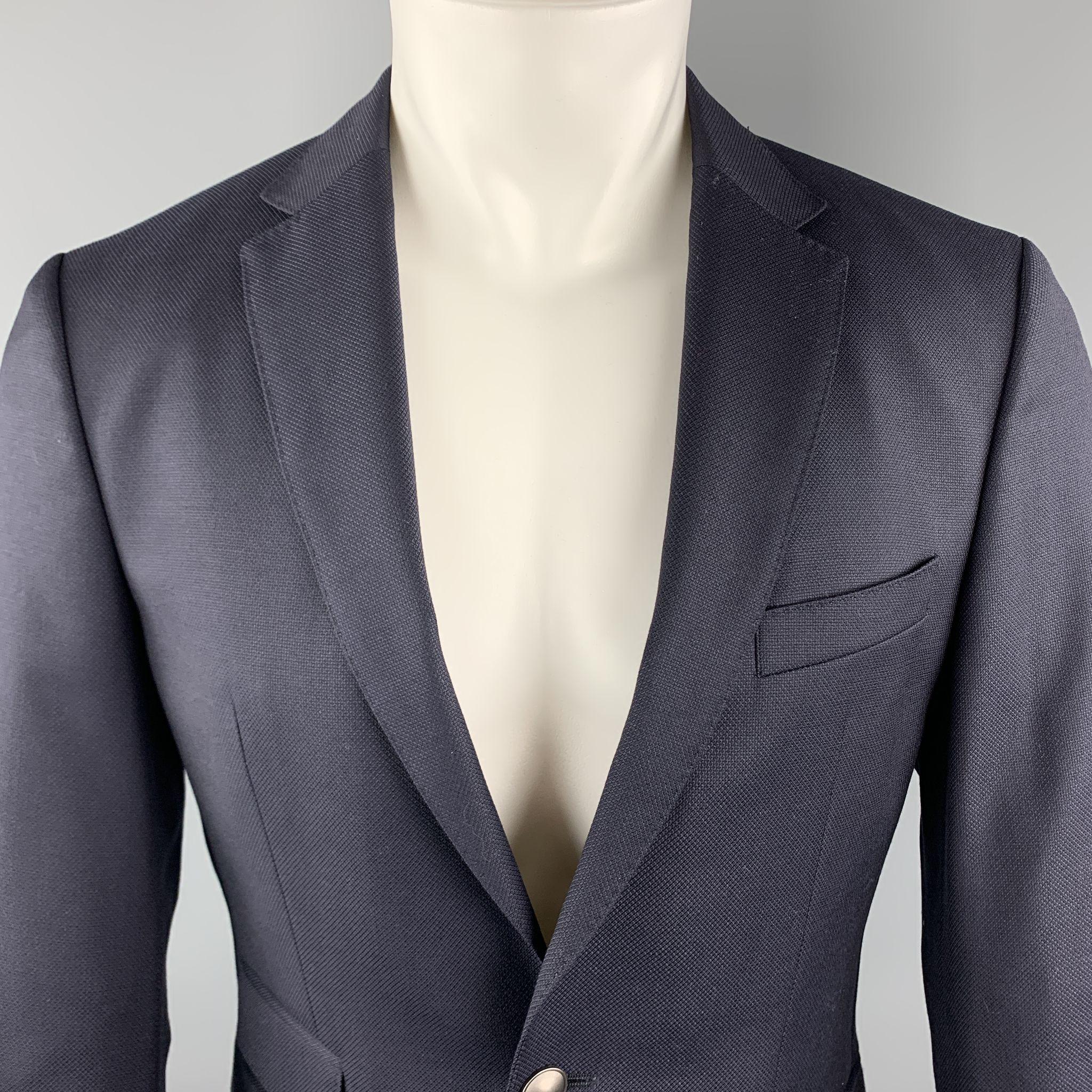 HUGO BOSS Sport Coat comes in a navy woven wool featuring a notch lapel style, flap pockets, and a two button closure. 

Excellent Pre-Owned Condition.
Marked: 46

Measurements:

Shoulder: 17 in. 
Chest: 36 in. 
Sleeve: 25 in. 
Length: 28 in. 

SKU: