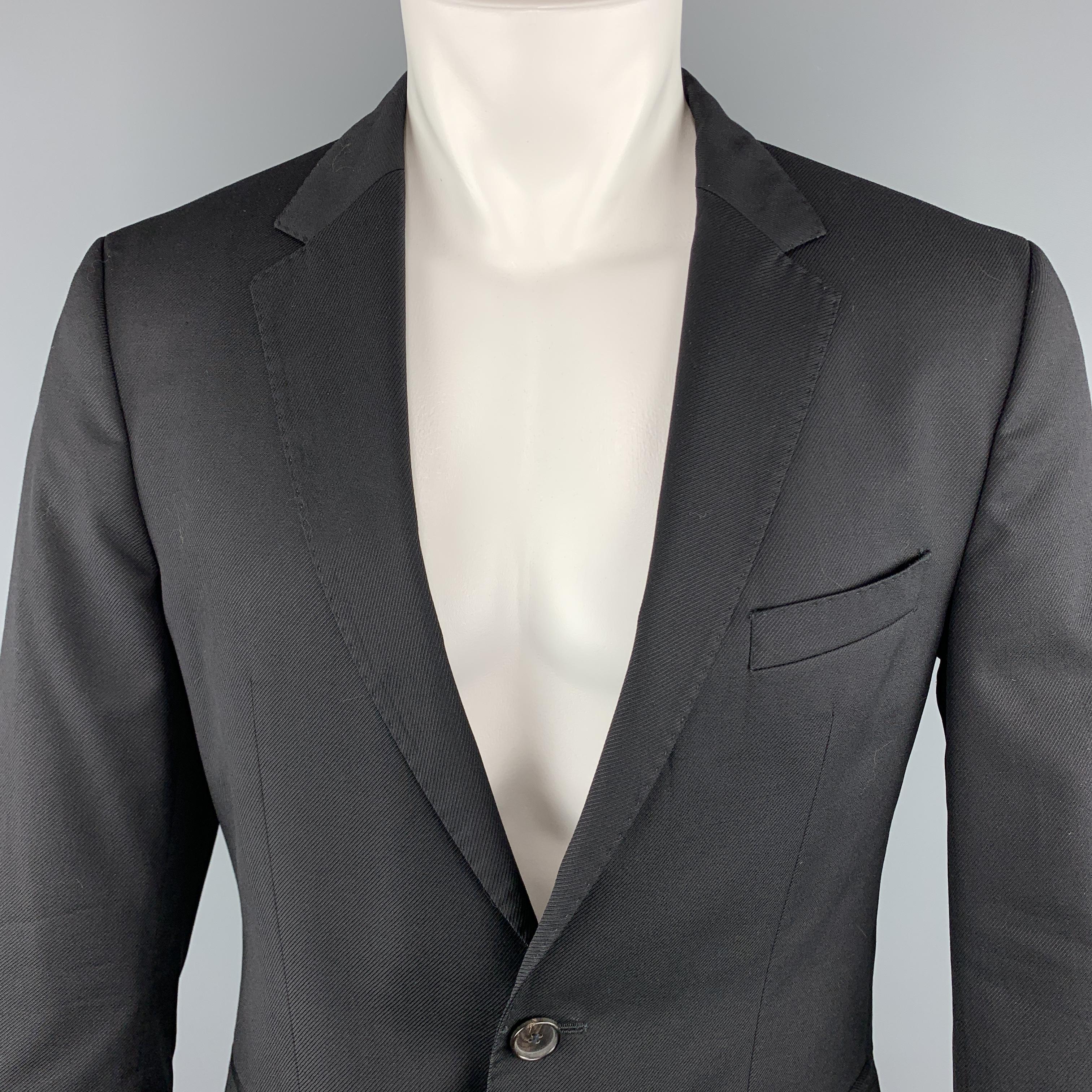 HUGO BOSS Sport Coat comes in a black tone in a striped texture wool material, with a notch lapel, slit and flap pockets, two buttons at closure, single breasted, a double vent at back, and buttoned cuffs. 

Excellent Pre-Owned Condition.
Marked:
