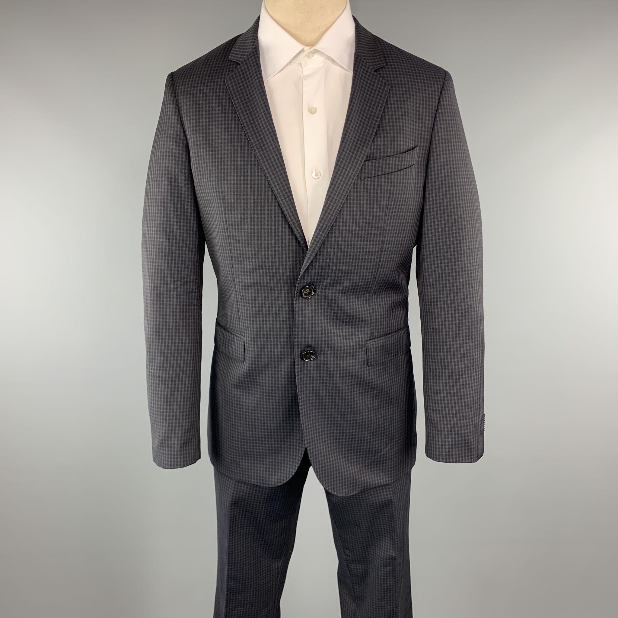 HUGO BOSS Suit comes in a navy checkered wool and includes a single breasted, two button sport coat with a notch lapel and matching front trousers. 

Excellent Pre-Owned Condition.
Marked: 50

Measurements:

-Jacket
Shoulder: 16 in. 
Chest: 40 in.