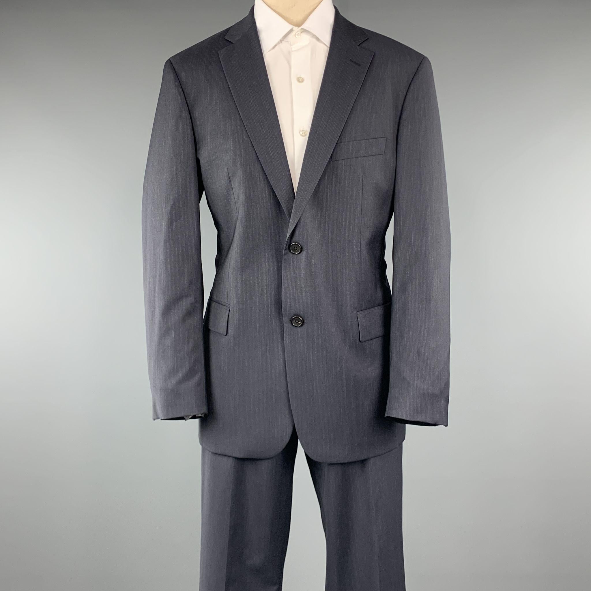 HUGO BOSS Suit comes in a charcoal pinstripe virgin wool and includes a single breasted, two button sport coat with a notch lapel and matching front trousers. Made in USA

Excellent Pre-Owned Condition.
Marked: 42

Measurements:

-Jacket
Shoulder: