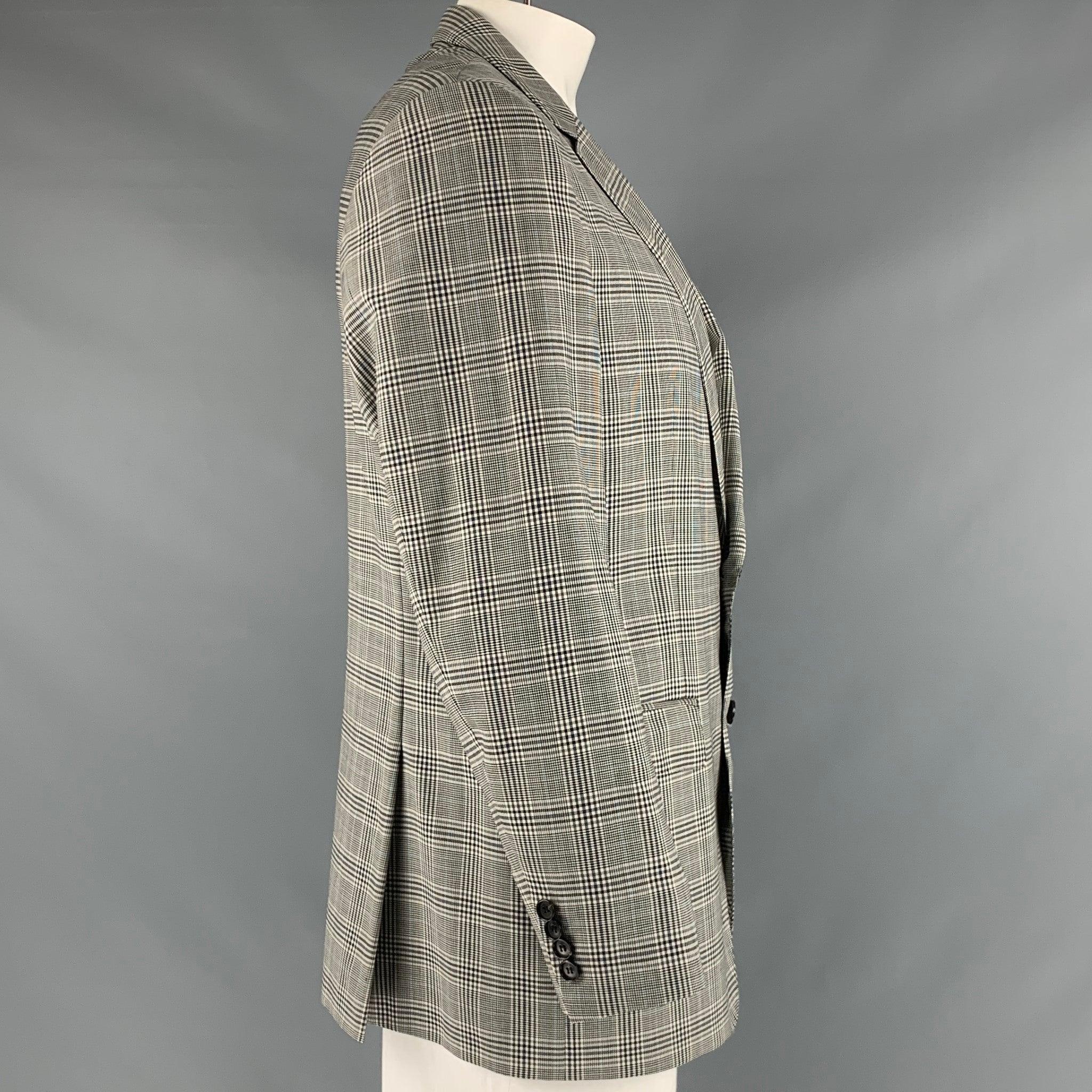 HUGO BOSS sport coat in a black, blue, and white virgin wool fabric featuring a glenplaid pattern, three pockets, and a single breasted two button closure.Very Good Pre-Owned Condition. 

Marked:   IT 54 

Measurements: 
 
Shoulder: 19 inches Chest:
