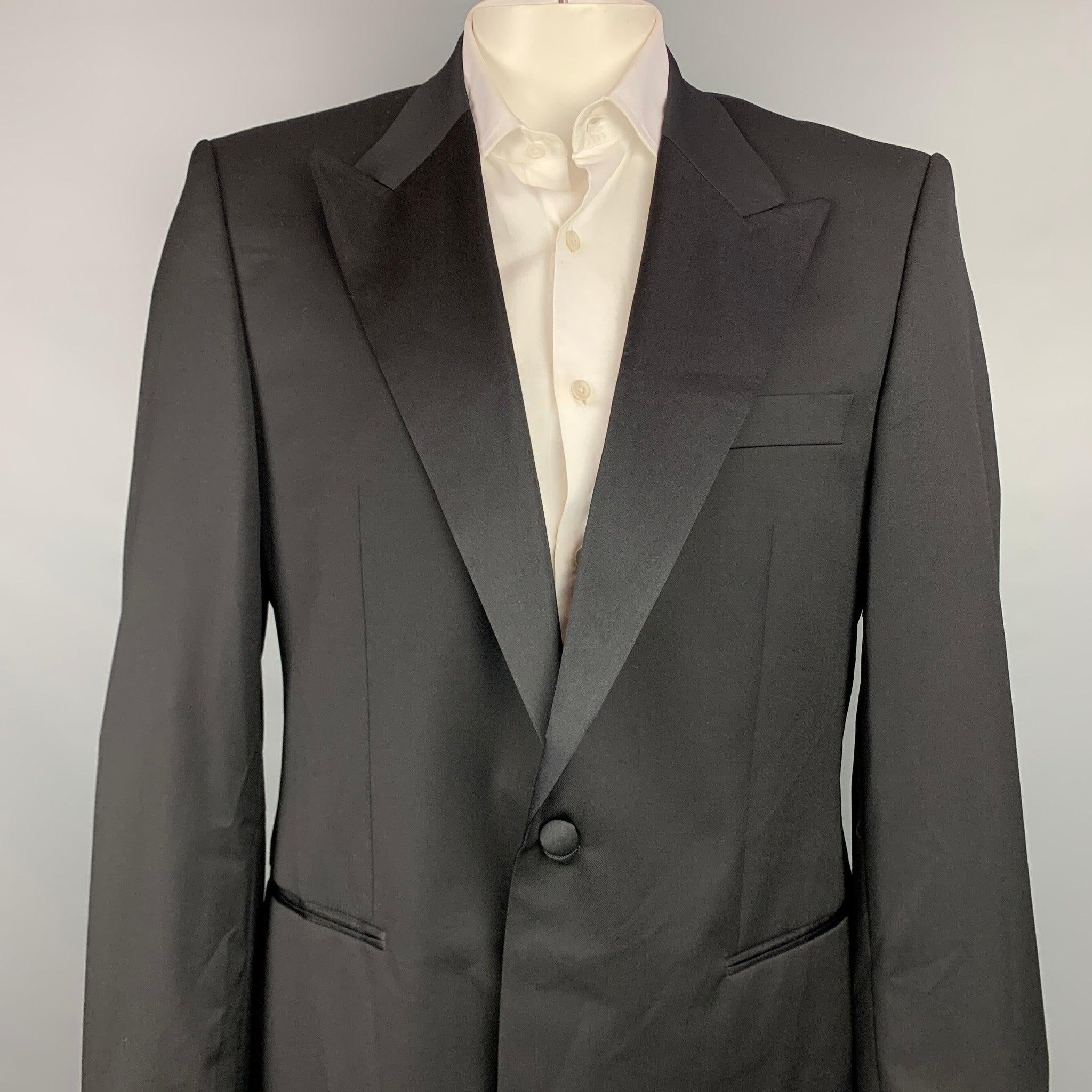 HUGO BOSS sport coat comes in a black wool with a full liner featuring a peak lapel, slit pockets, and a single button closure. Made in Bulgaria.New With Tags.
 

Marked:   US 44 R 

Measurements: 
 
Shoulder: 19 inches  Chest: 44 inches  Sleeve: