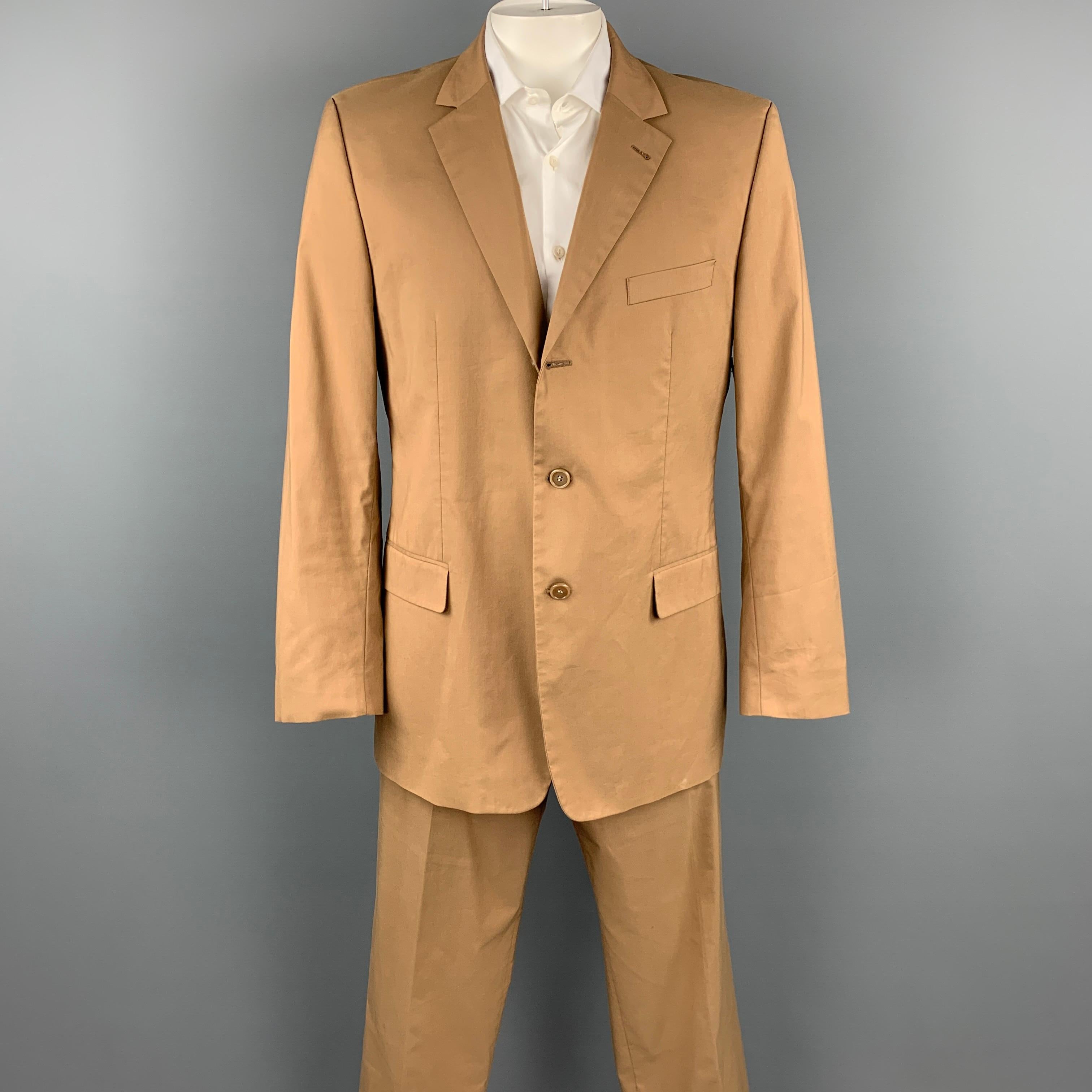 HUGO BOSS suit comes in a tan cotton with a full liner and includes a single breasted, three button sport coat with a notch lapel and matching flat front trousers.

Good Pre-Owned Condition.
Marked: 54

Measurements:

-Jacket
Shoulder: 19 in.
Chest: