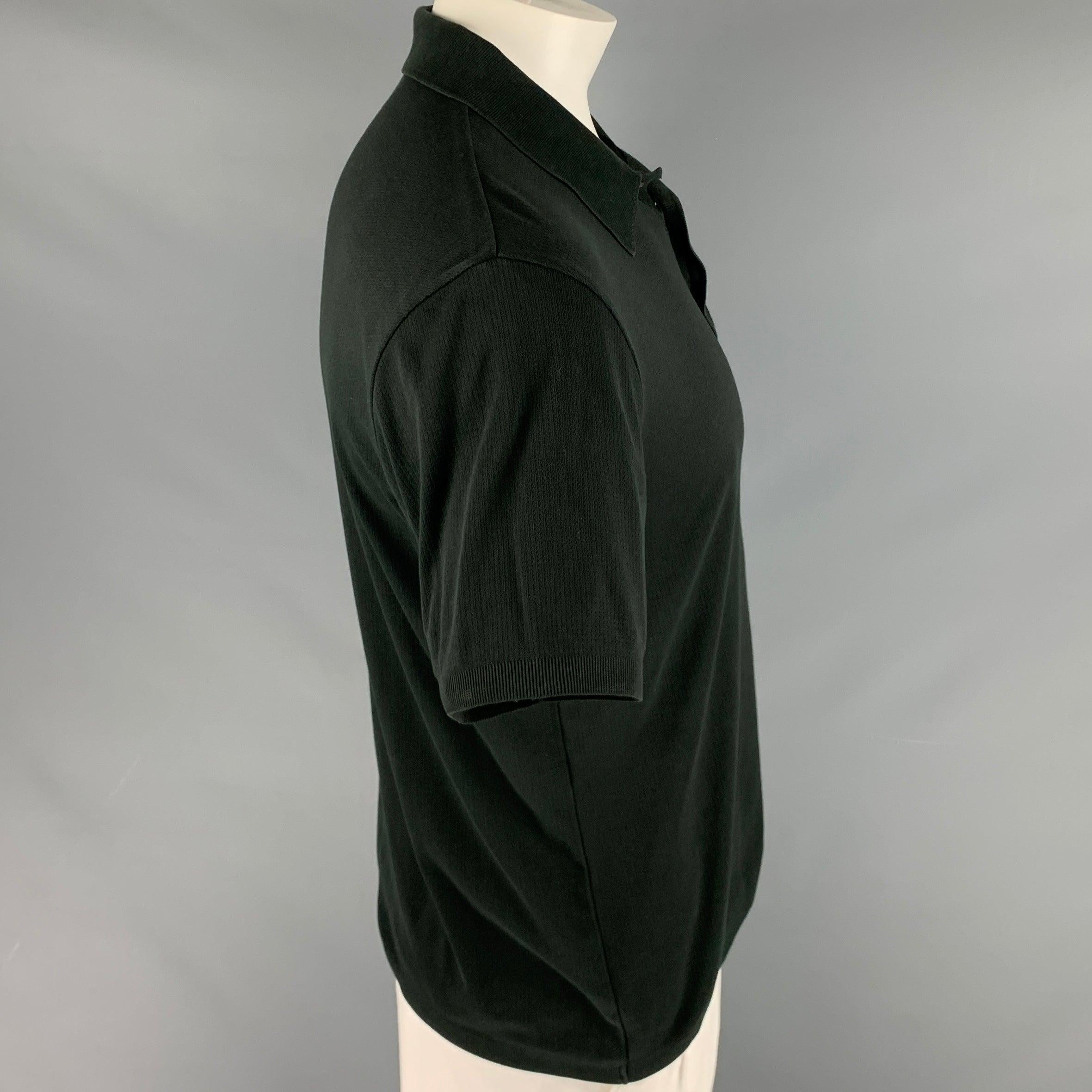 BOSS by HUGO BOSS polo
in a
black cotton blend featuring a breathable knit style, spread collar, and half placket button closure.Excellent Pre-Owned Condition. 

Marked:   L 

Measurements: 
 
Shoulder: 18.5 inches Chest: 44 inches Sleeve: 9 inches