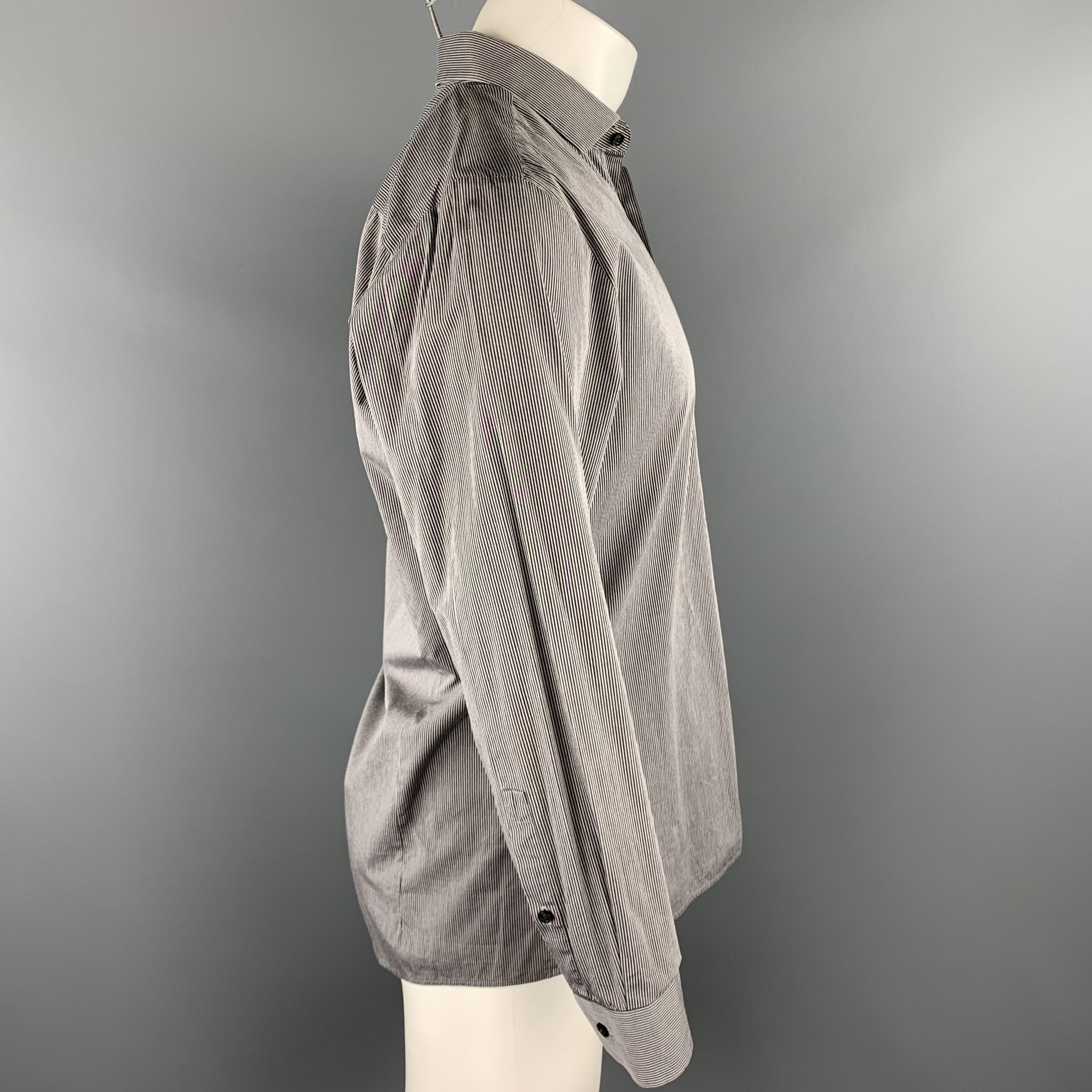 HUGO BOSS long sleeve shirt comes in a gray stripe cotton blend featuring a button up style and a spread collar.

Very Good Pre-Owned Condition.
Marked: 15.5/32

Measurements:

Shoulder: 17.5 in. 
Chest: 40 in. 
Sleeve: 24 in. 
Length: 29 in. 
SKU: