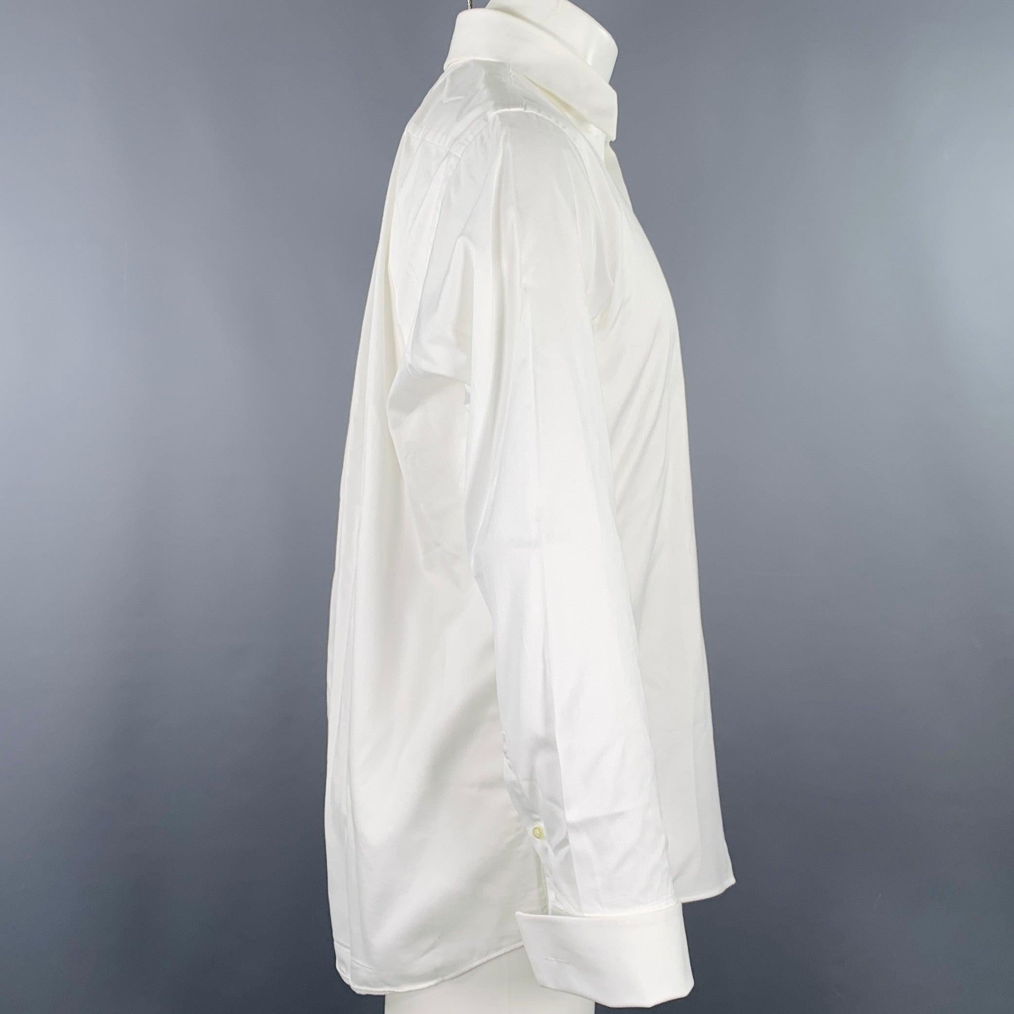 BOSS by HUGO BOSS long sleeve shirt
in a white cotton woven fabric featuring spread collar, removable button trim (for the option of using formal tuxedo studs), and French cuffs. Cufflinks not included. Very Good Pre-Owned Condition. Moderate but