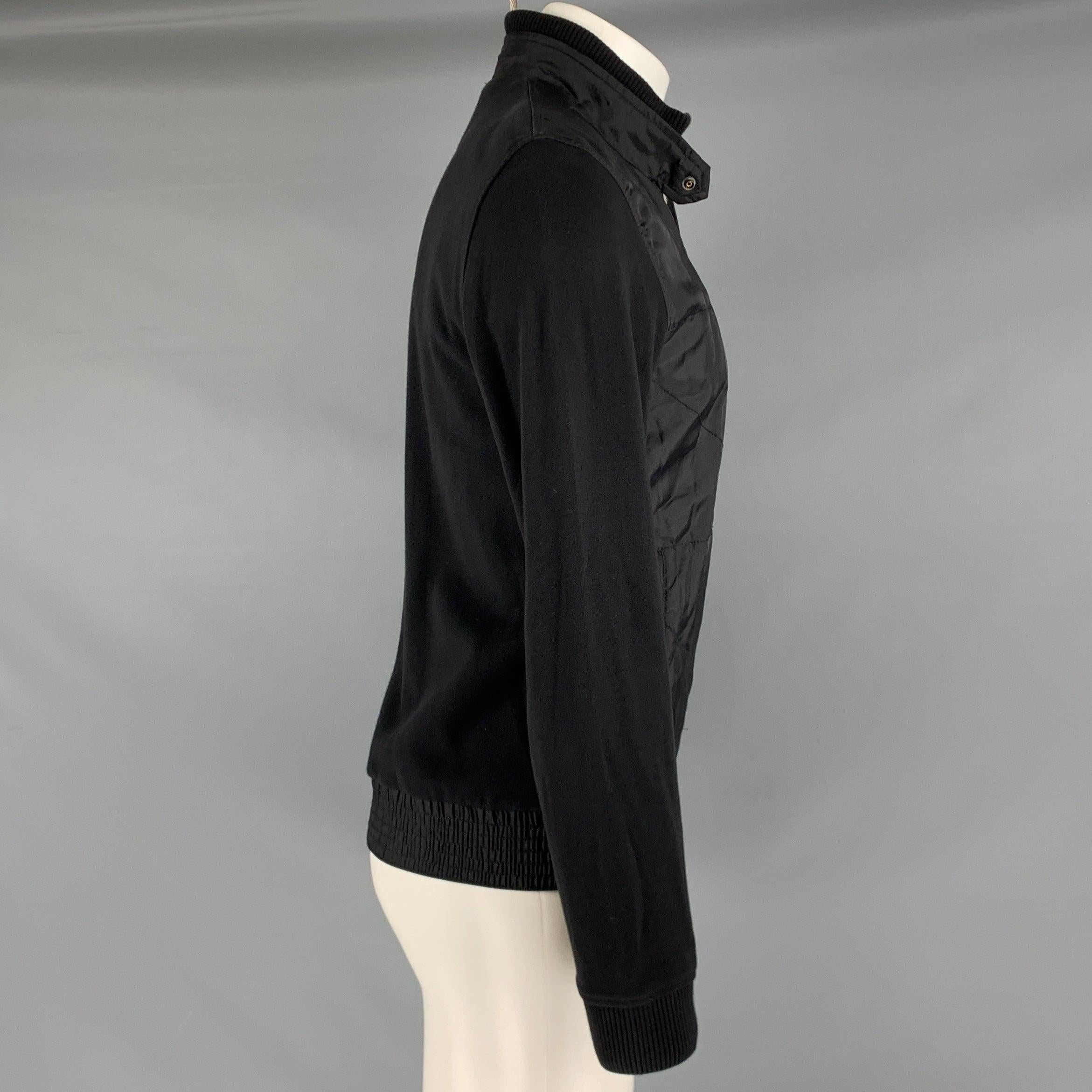 HUGO BOSS jacket
in a black cotton nylon fabric featuring a mixed fabrics style, regular fit, and zip up closure.Good Pre-Owned Condition. Moderate signs of wear, please check photos. 

Marked:   S 

Measurements: 
 
Shoulder: 17 inches Chest: 39