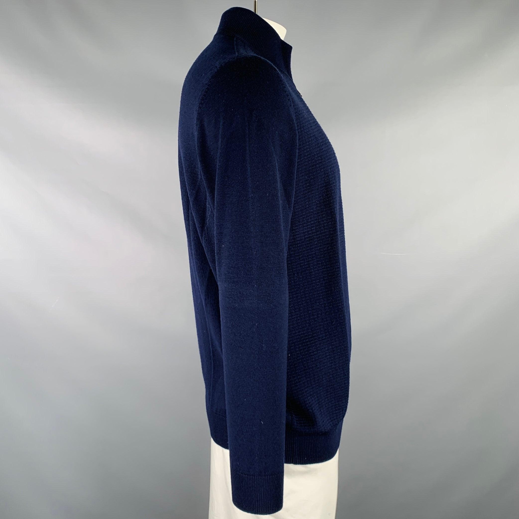 HUGO BOSS cardigan in a navy merino wool knit featuring a waffle knit front, regular fit, and zip up closure.Very Good Pre-Owned Condition. Minor signs of wear. 

Marked:   XL 

Measurements: 
 
Shoulder: 19 inches Chest: 47 inches Sleeve: 26 inches