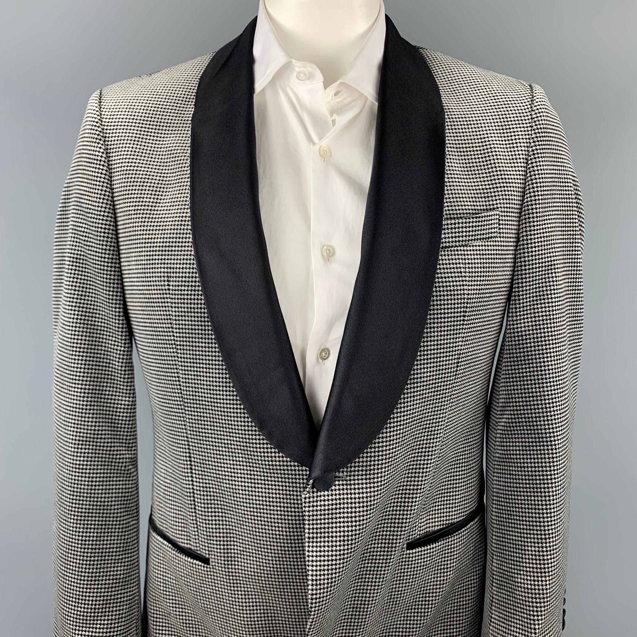 HUGO BOSS sport coat comes in a grey & black houndstooth cotton velvet with a full black liner featuring a shawl lapel, slit pockets, and a single button closure. 

Very Good Pre-Owned Condition.
Marked: 42 R

Measurements:

Shoulder: 18.5