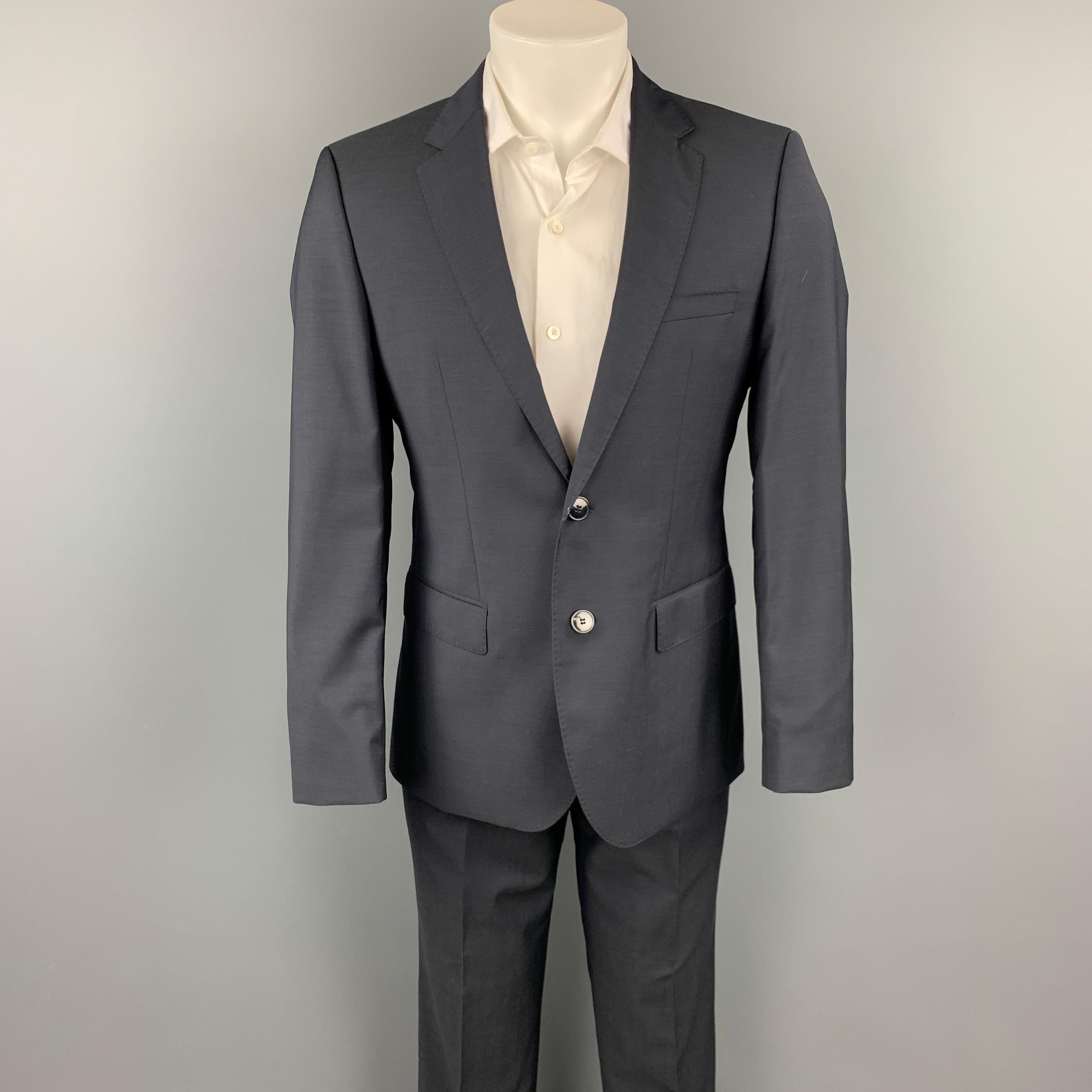 HUGO by HUGO BOSS suit comes in a dark blue virgin wool with a full liner and includes a single breasted, two button sport coat with a notch lapel and matching flat front trousers. Pants have been altered.

New With Tags.
Marked: 36 R
Original