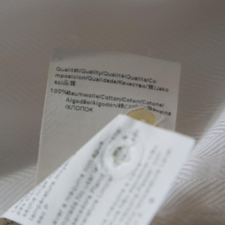 A classic white shirt is a wardrobe essential and what better than this Hugo by Hugo Boss creation! It is made of 100% cotton and features a herringbone pattern. It flaunts sharp collars, front button fastenings and long sleeves. It is sure to lend