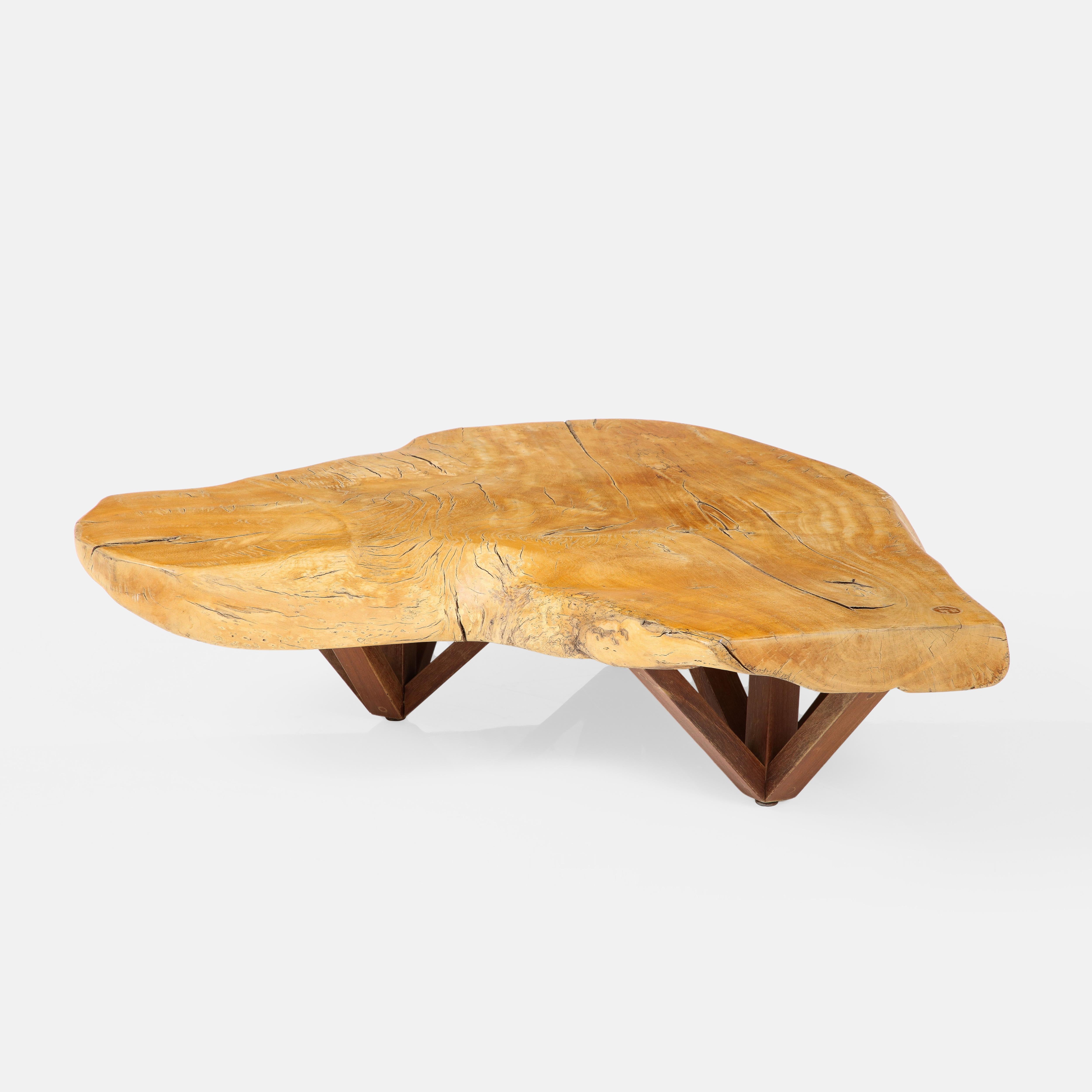 Hugo Franca and Paolo Alves coffee table with live edge slab of pequi wood atop three sets of architectural wood bases, Brazil, circa 2016. This impressive and unique coffee table came from Hugo Franca's own private collection. 
Impressed signature