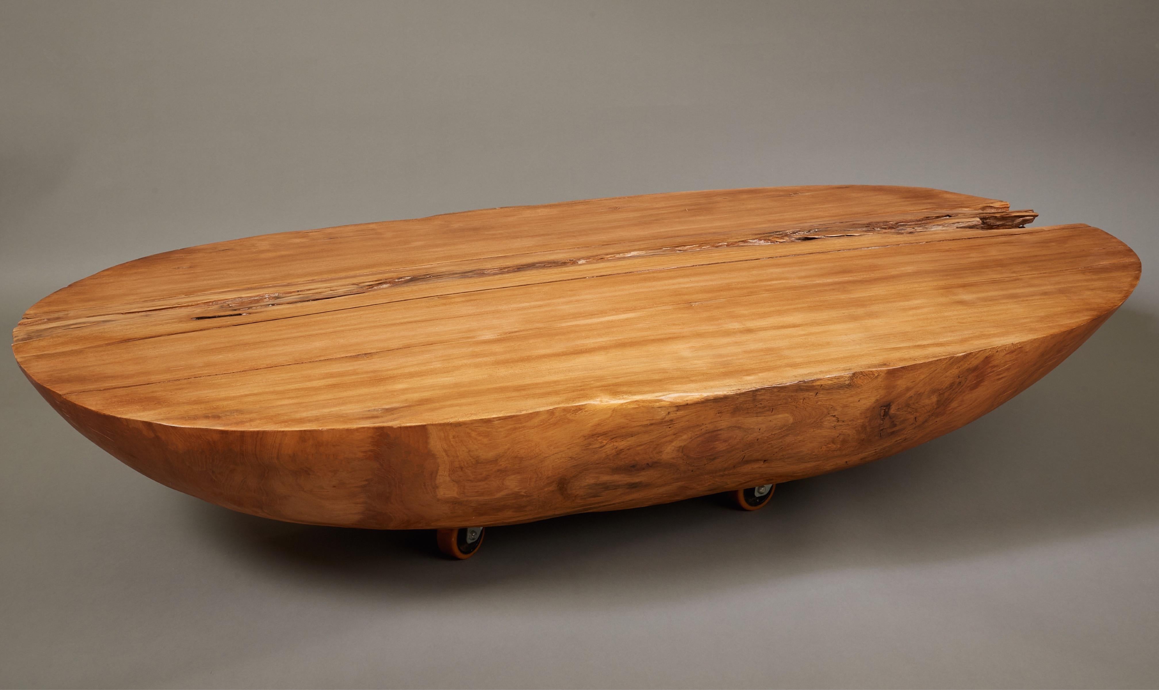 Hugo França (b. 1954)

A phenomenal, monumental oval coffee table by Brazilian woodworker Hugo França, in reclaimed pequi wood raised on four casters. Expertly crafted from a massive slab of Brazilian hardwood, salvaged from old-growth trees felled