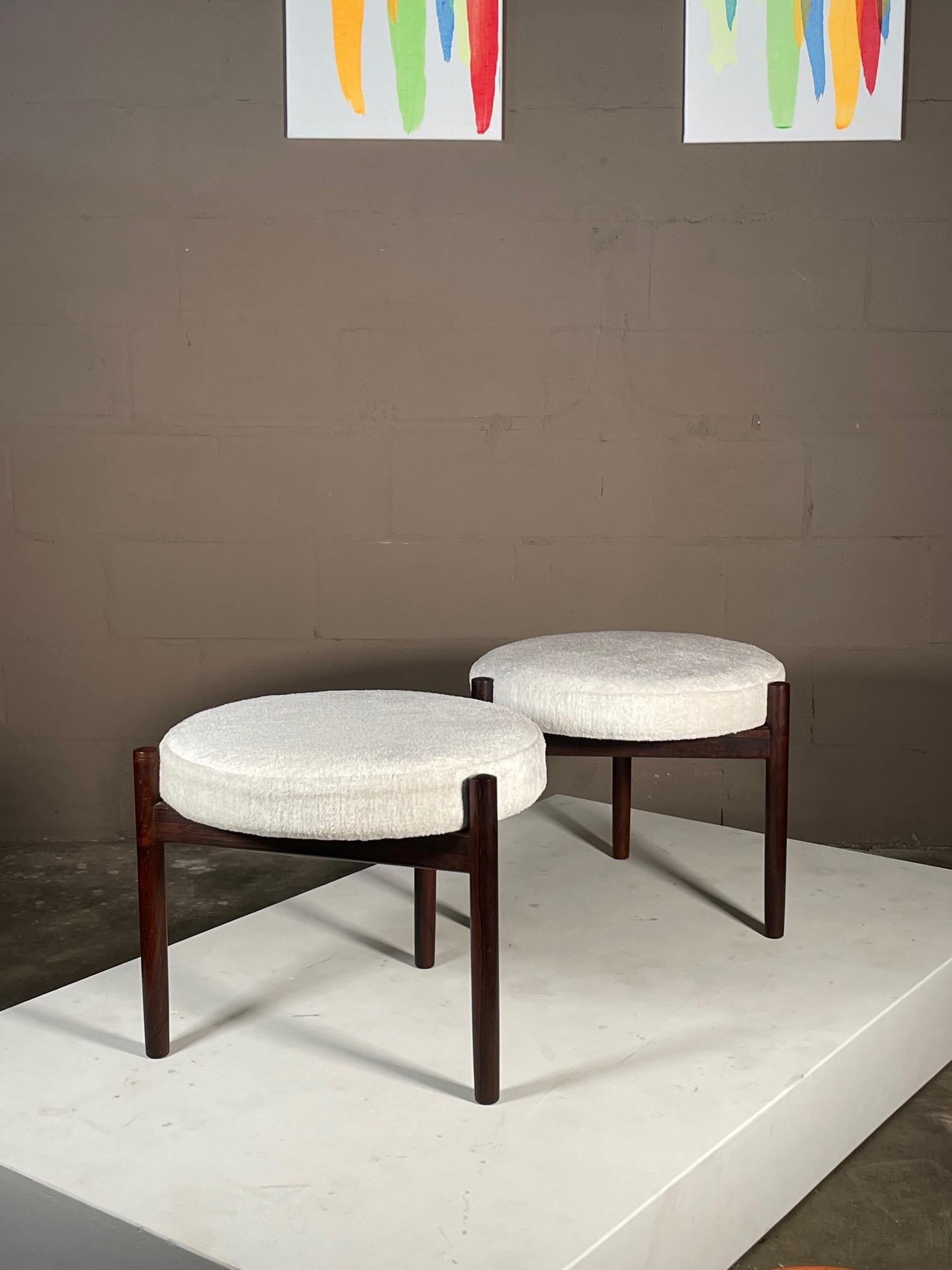 A pair of Hugo Frandsen ottomans for Spottrup, Denmark, ca'1960's. Rosewood tripod bases.