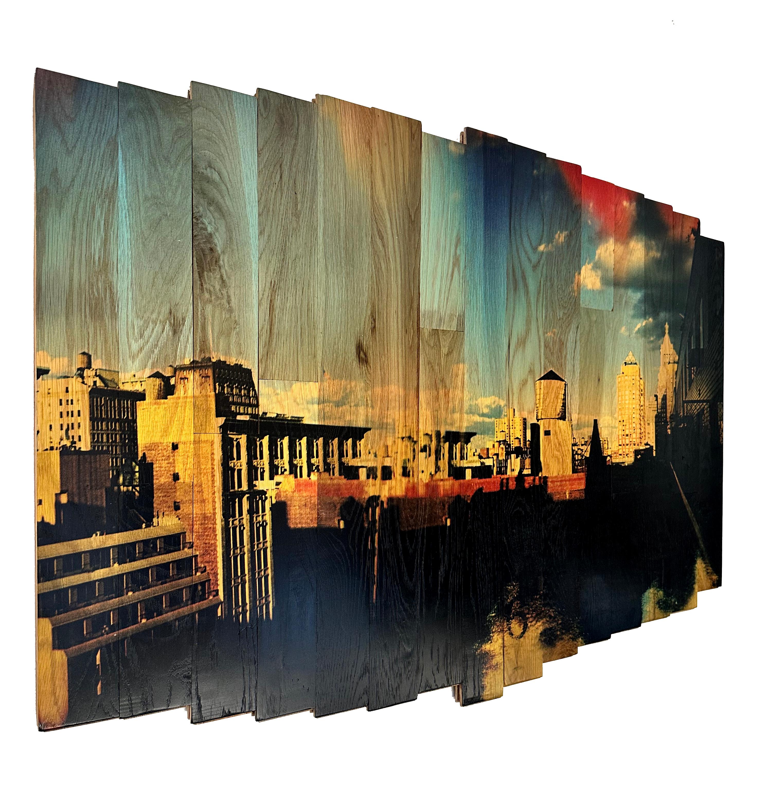 Soaring Sky High, part of the “Wooden Postcards” series, lifts the viewer above Union Square’s rooftops, capturing New York’s iconic water towers against a vast blue sky. Shot with a Holga camera and cross-processed medium format film, the scene is