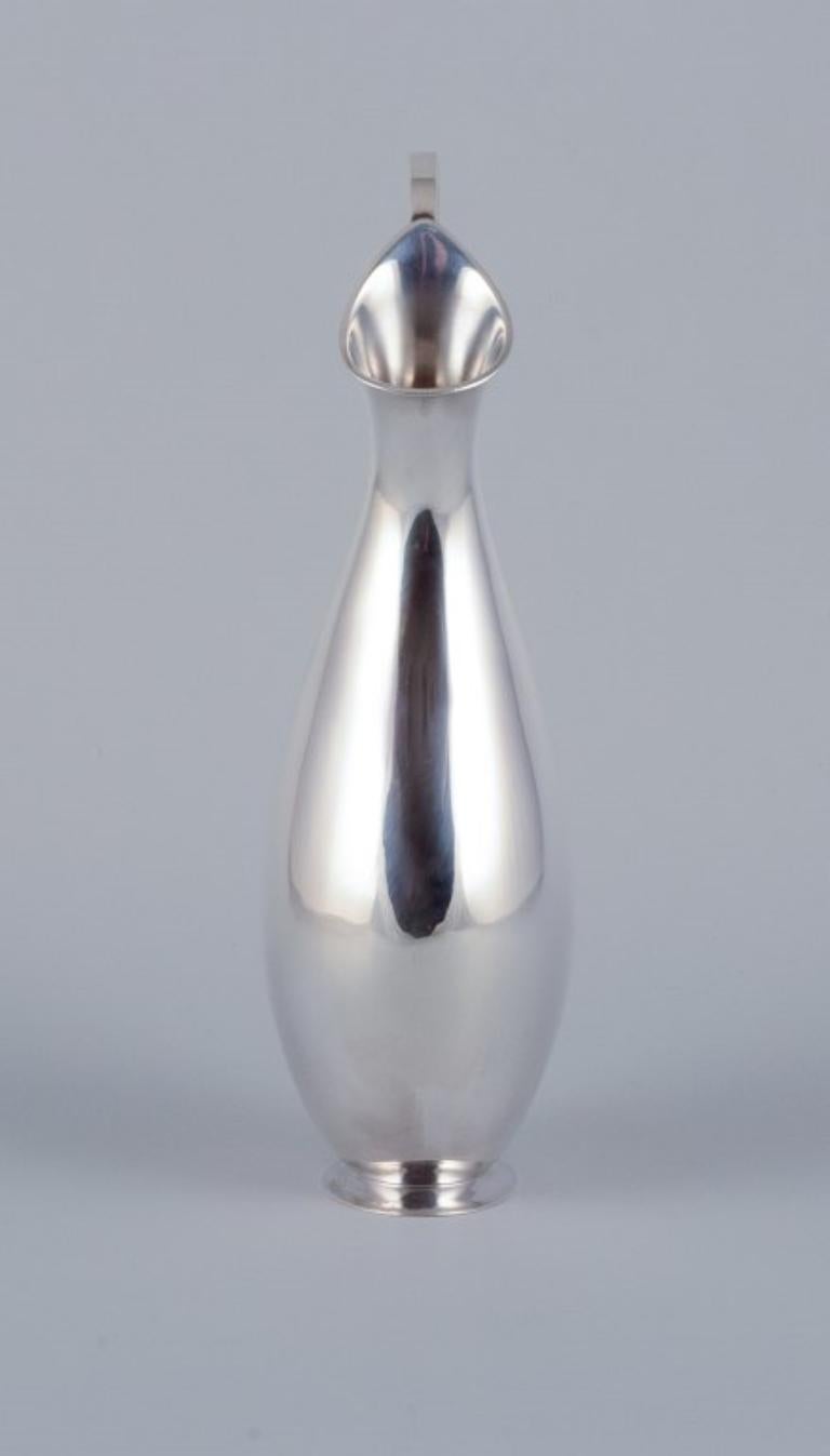 Scandinavian Modern Hugo Grün, Danish silversmith. Modernist pitcher in sterling silver. For Sale