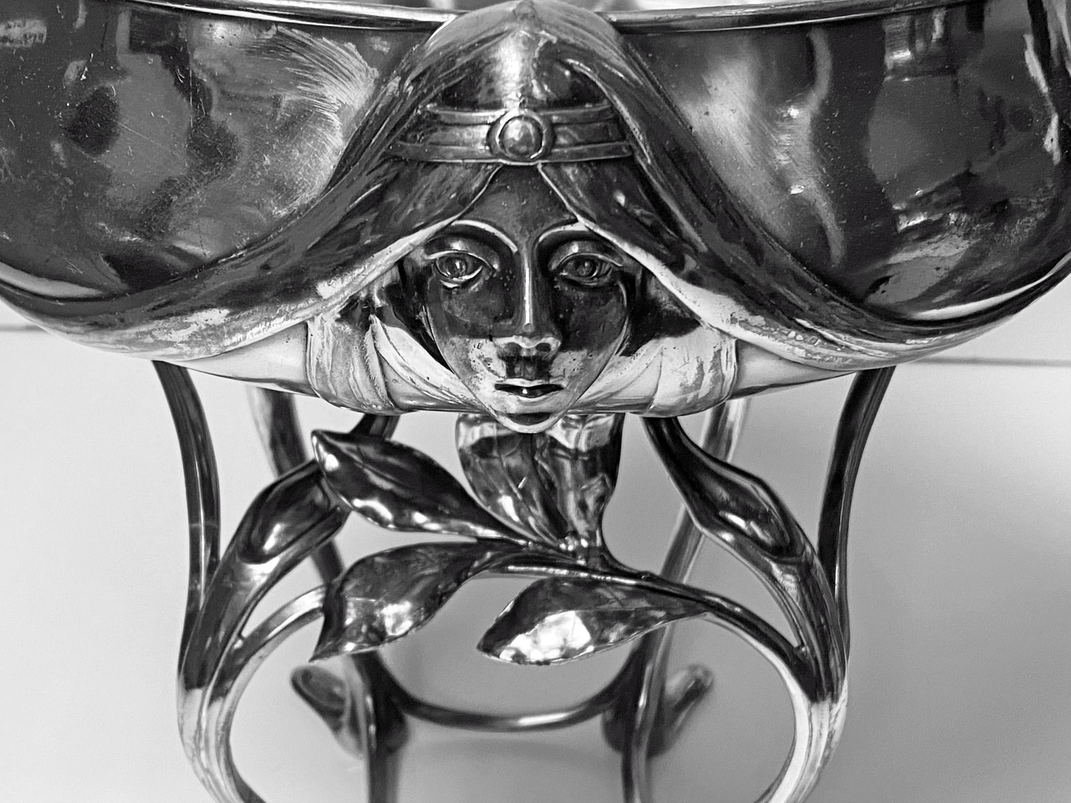 Hugo Leven Art Nouveau Centrepiece, pewter silver plated Germany, circa 1890,depicting a maidenhead with hair flowing around the bowl. Signed twice H. Leven, size: diameter 10.25 inches, width from handle to handle is 16 inches, height 11.50 inches.