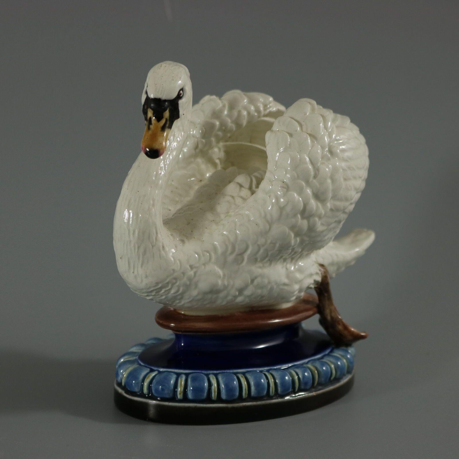 Lonitz Majolica figure which features a swan in a swimming pose. Colouration: white, blue, brown, are predominant. The piece bears maker's marks for the Lonitz pottery. Bears a pattern number, '1767'.