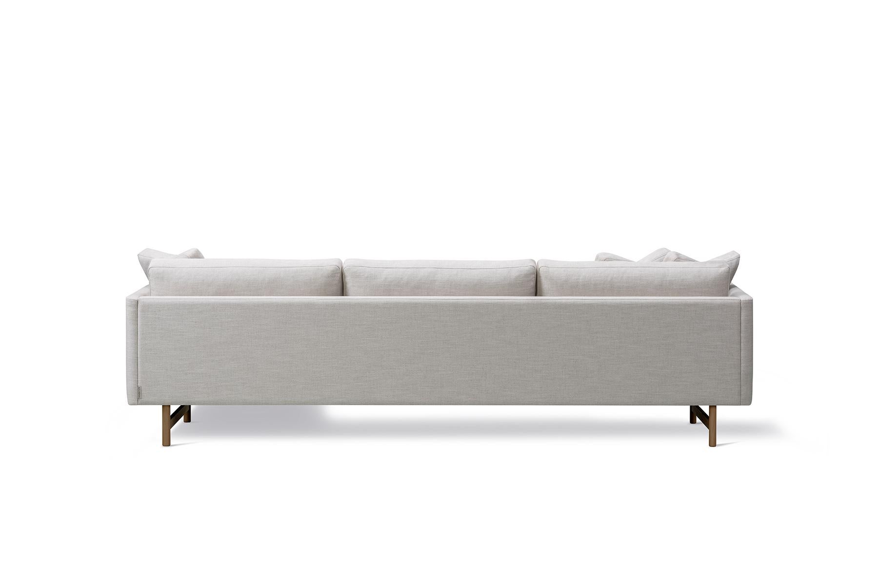 Hugo Passos Calmo sofa 80 – 3-seater – chaise – wood base is simple and serene in this expansive 3-seater Calmo sofa, where straight lines converge with discrete curved details. Comfy cushions complete the picture in this understated expression of
