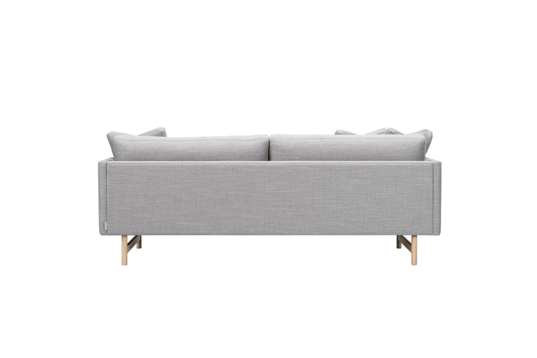 Hugo Passos Calmo sofa 95 – 2-seater – wood base is simple and serene in this expansive 3-seater Calmo sofa, where straight lines converge with discrete curved details. Comfy cushions complete the picture in this understated expression of elegance.