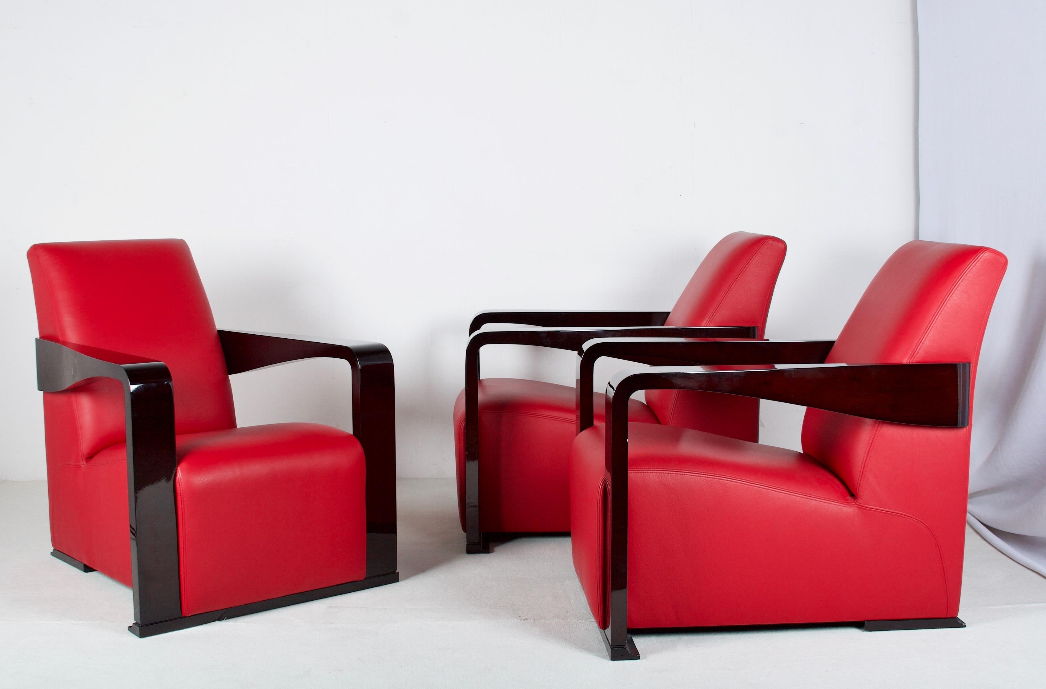 A very stylish and comfortable lounge chair in red leather
with top stitching details, finished with dark lacquered
walnut arms and base details. .These chairs are heavy,
wonderful and well made. 
They can be purchased individually, although