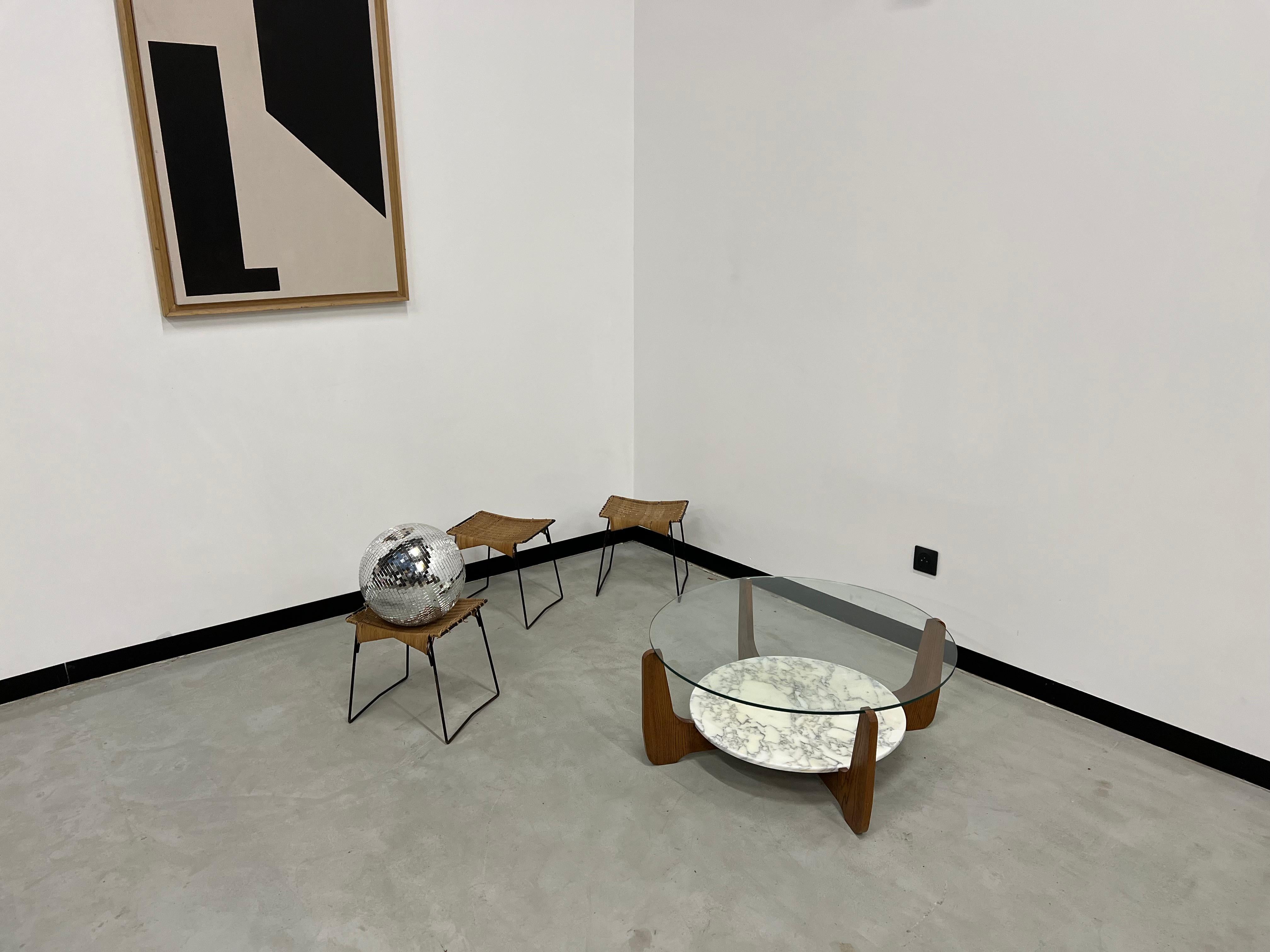 Very beautiful coffee table from the 70s by designer Hugues Poignant. Rosewood veneered and resting on four legs connected by two cross spacers. Two round tops, one in glass and the other in white marble. Note that a restoration was made on the