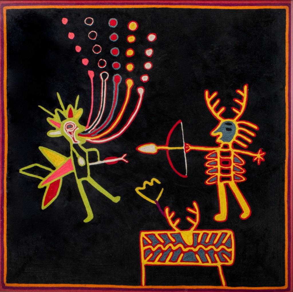 Mexican Huichol Niereka art textile depicting two figures, one with deer antlers shooting a bow and arrow at an anthropomorphic zoomorphic figure, housed under glass in a silver-tone metal frame. 24