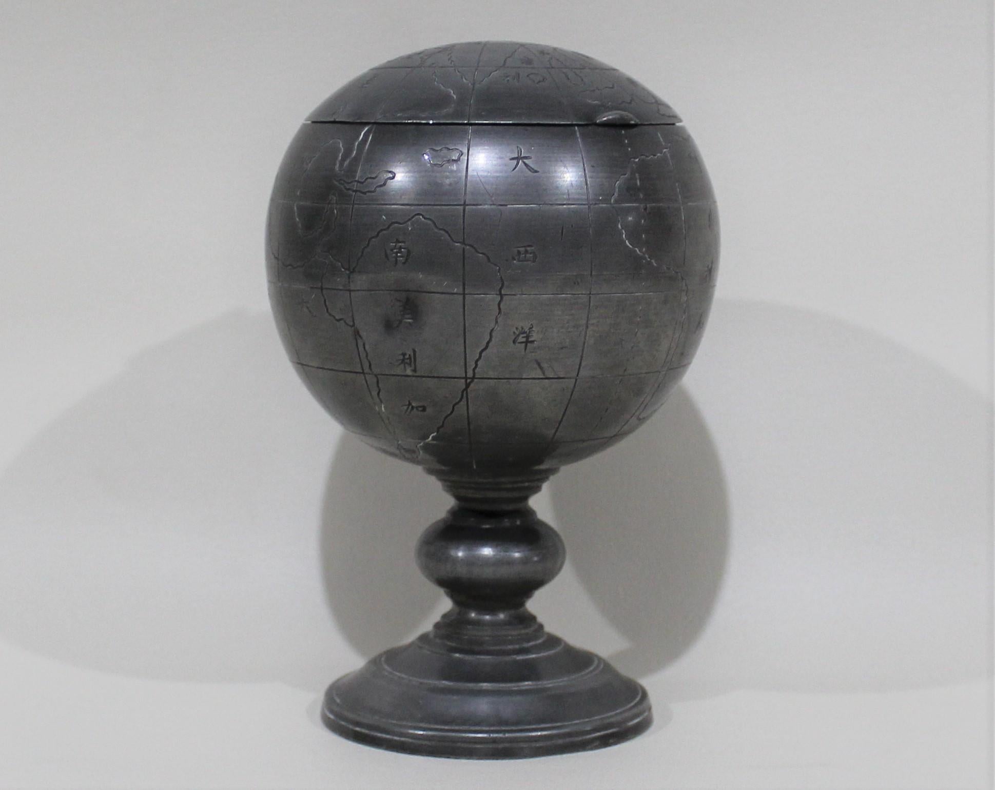 Chinese Huikee Swatow pewter tobacco container in the shape of a terrestrial globe with Chinese characters throughout.

 
