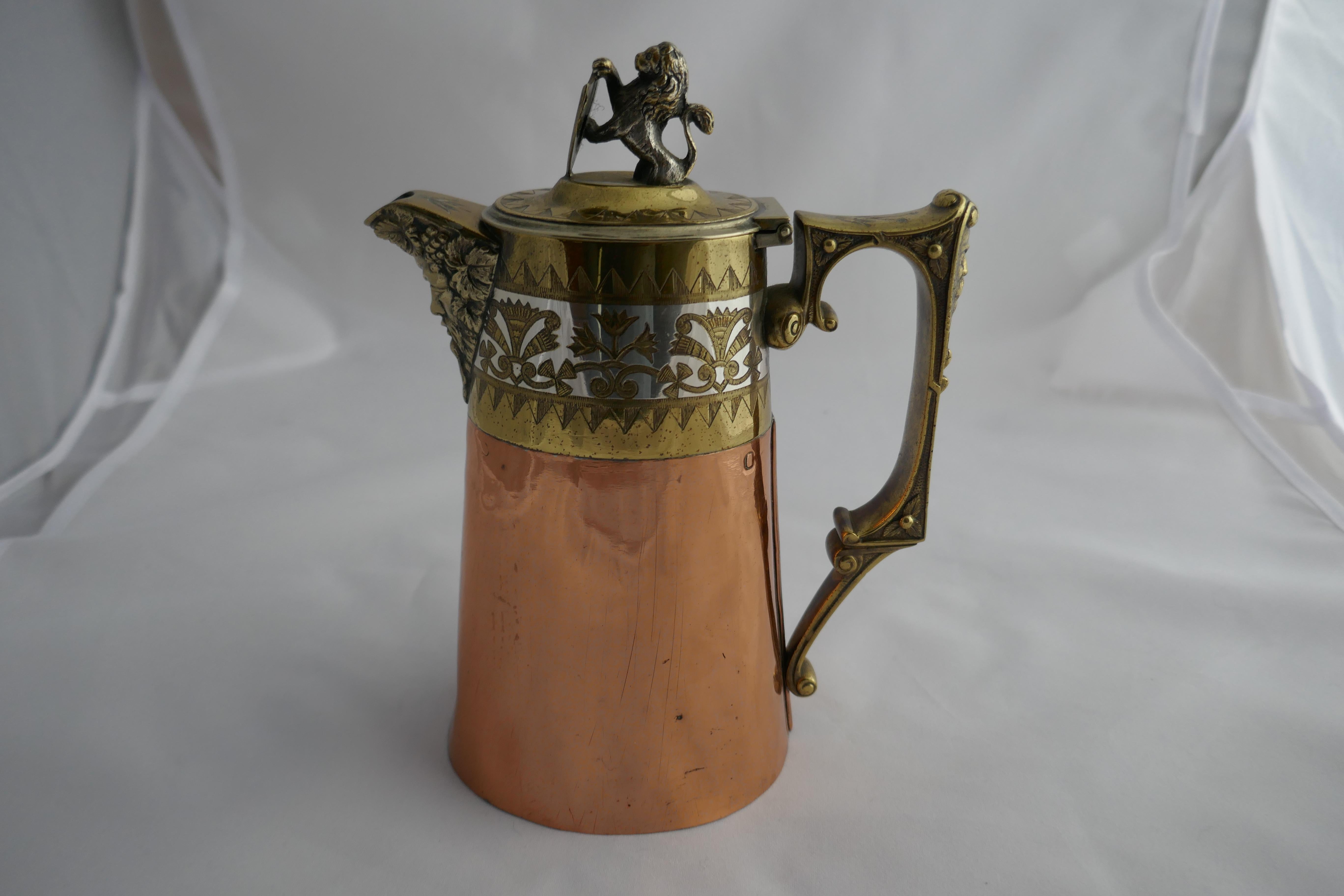 Hukin and heath coffee or chocolate pot, Arts & Crafts Gothic style

This is a very unusual piece, the main body of the pot is copper the handle and the upper section of the pot are brass and silver
The handle and spout have a grotesque face and