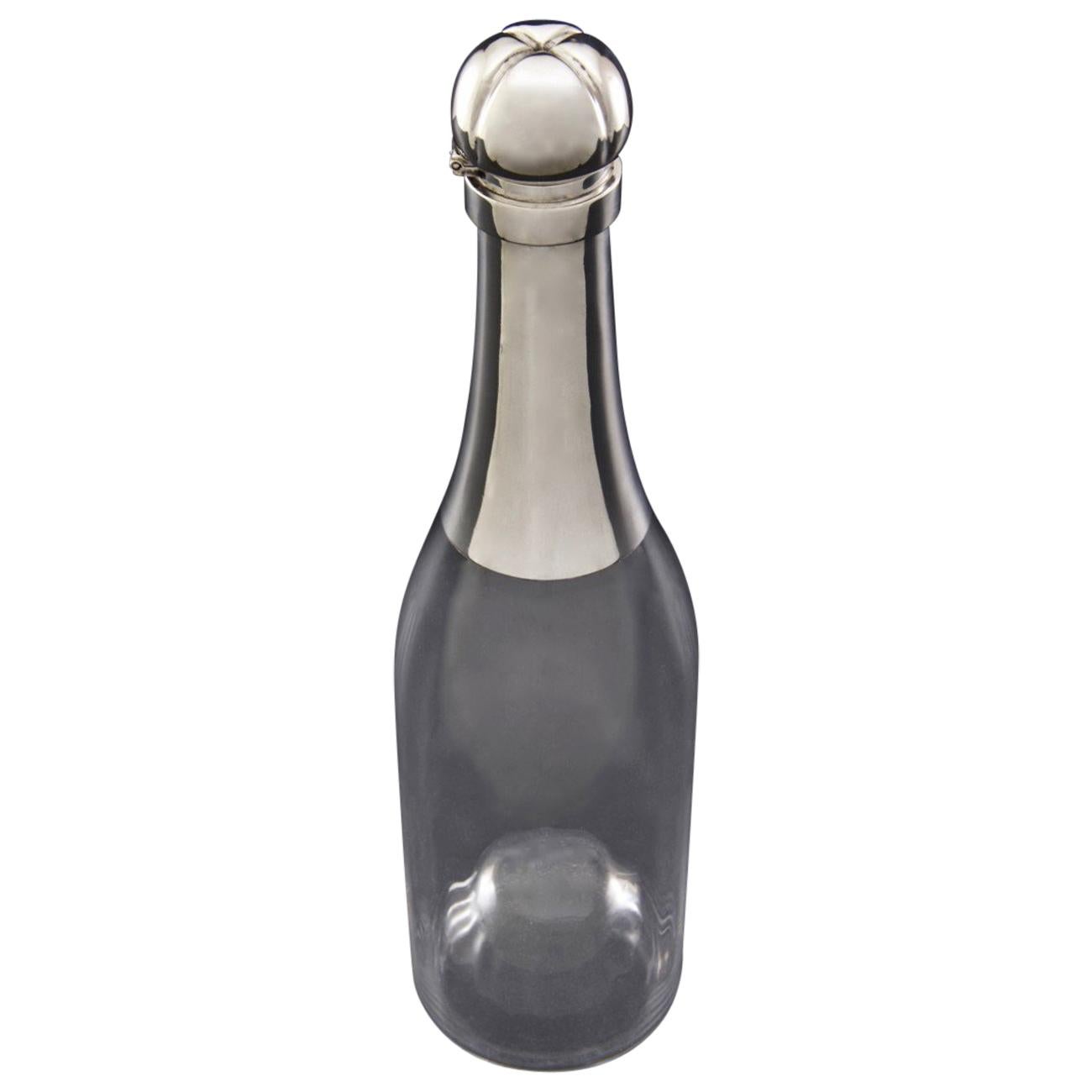 Wonderful sterling silver and glass decanter with a bottle capacity, modelled as a Champagne bottle. The glass body is fluted, but in a truly elegant fashion, on the inside only; so that the outside surface of the decanter remains smooth. The