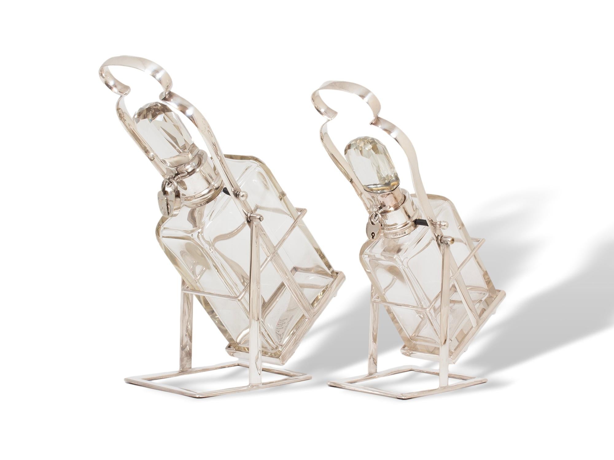 20th Century Hukin & Heath Pair of Silver Tilting Liquor Decanters For Sale