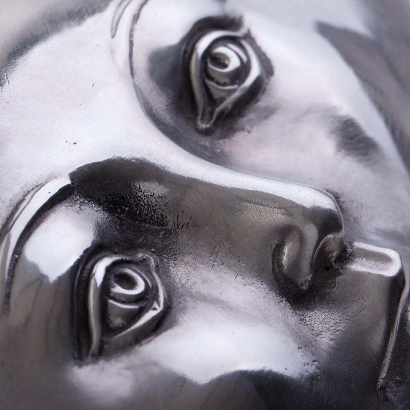 Symbolizing a cure for society's ills, this typically surreal sculpture by Florentine artist Leonardo Bossio depicts a large pill with an intricately sculpted human face. Hand-cast in aluminum and polished to a glazed finish.
