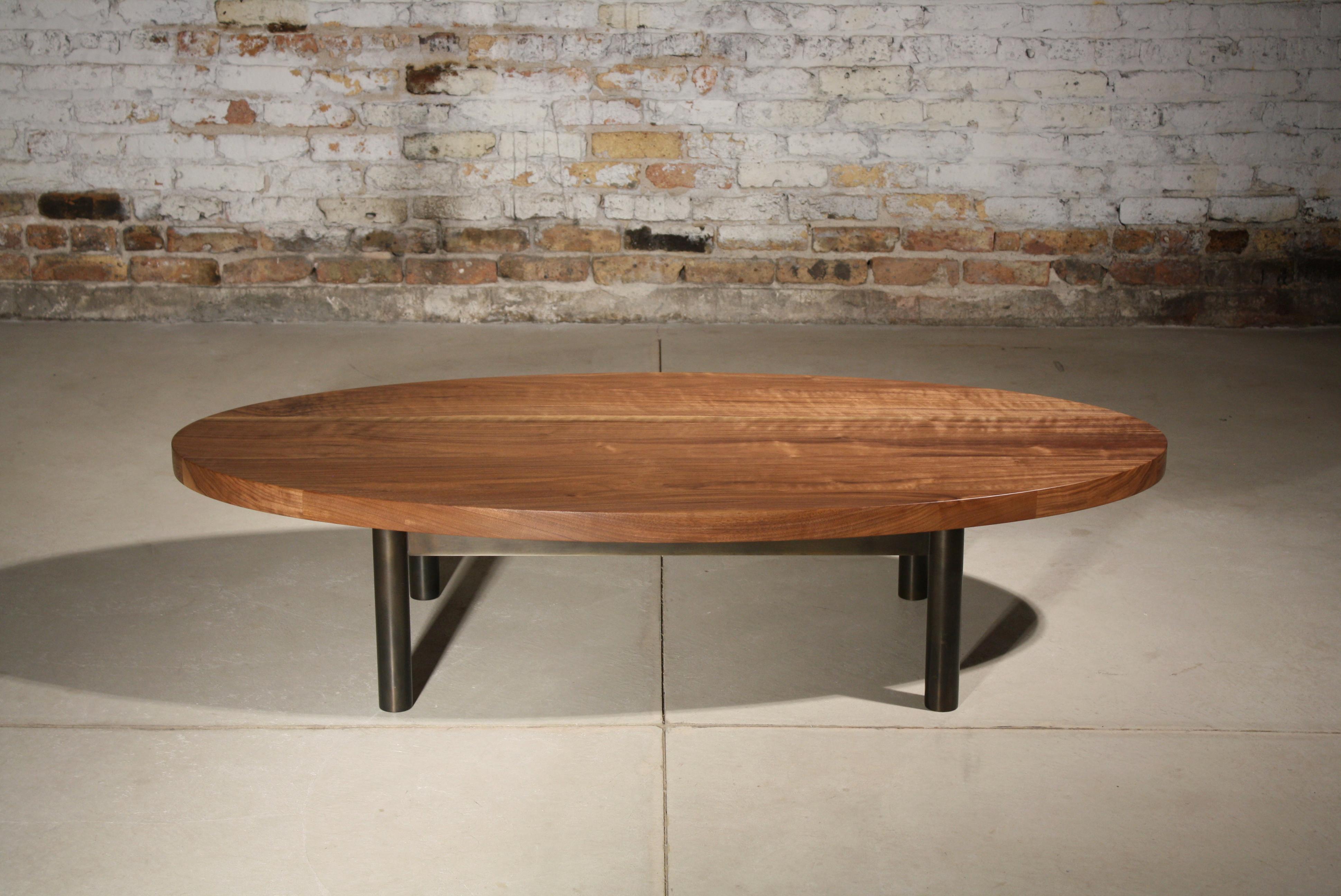 shown in natural walnut and blackened steel with an oval top

Measures: 60