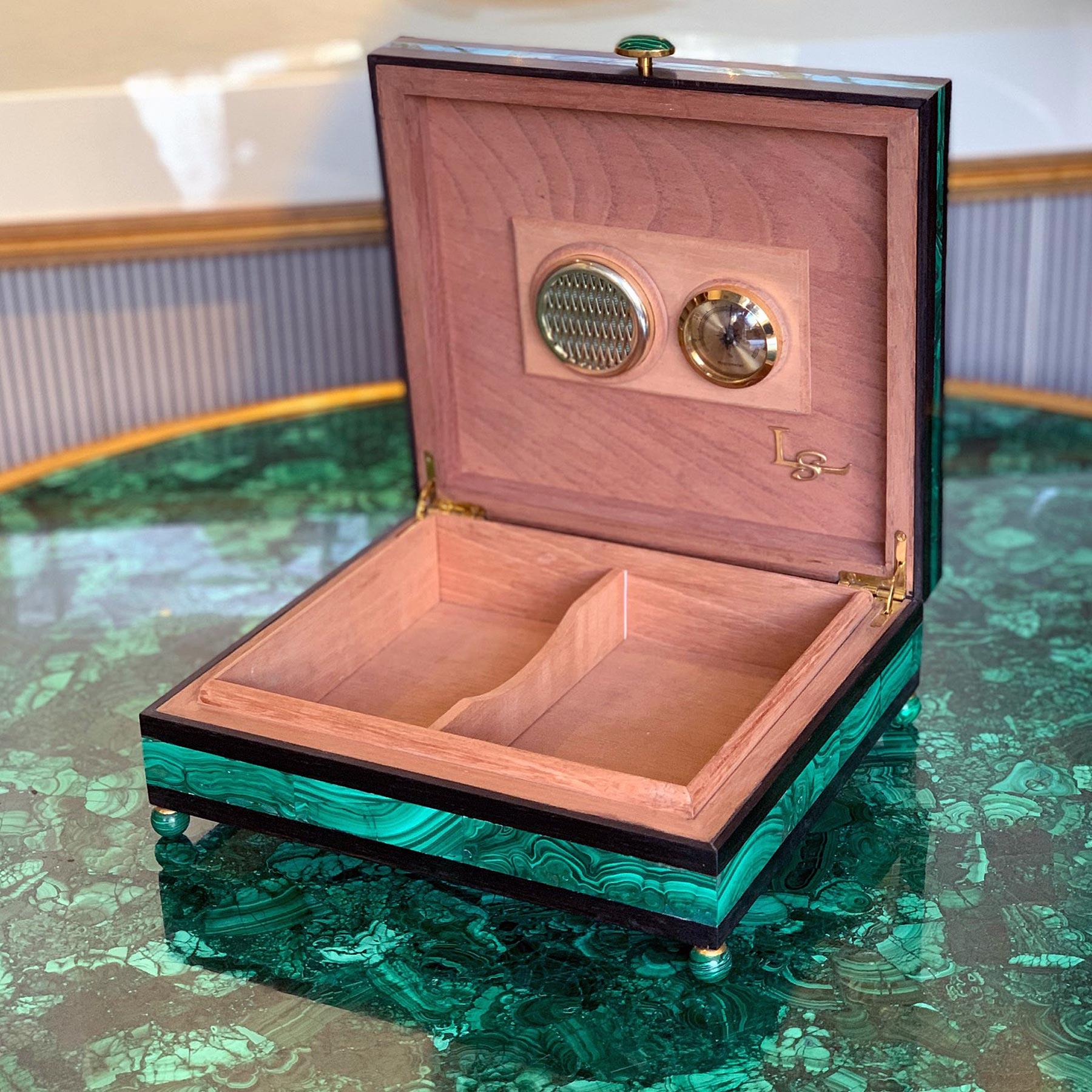 An ebony humidor lined with Spanish Cedar, inlaid with malachite banding on the sides and a map of Russia on the top with Diamonds showing the location of Moscow and St Petersburg and a gilt bronze Russian Brown Bear mounted on the top of the