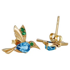 Orecchini con colibrì e topazi blu in oro 14k