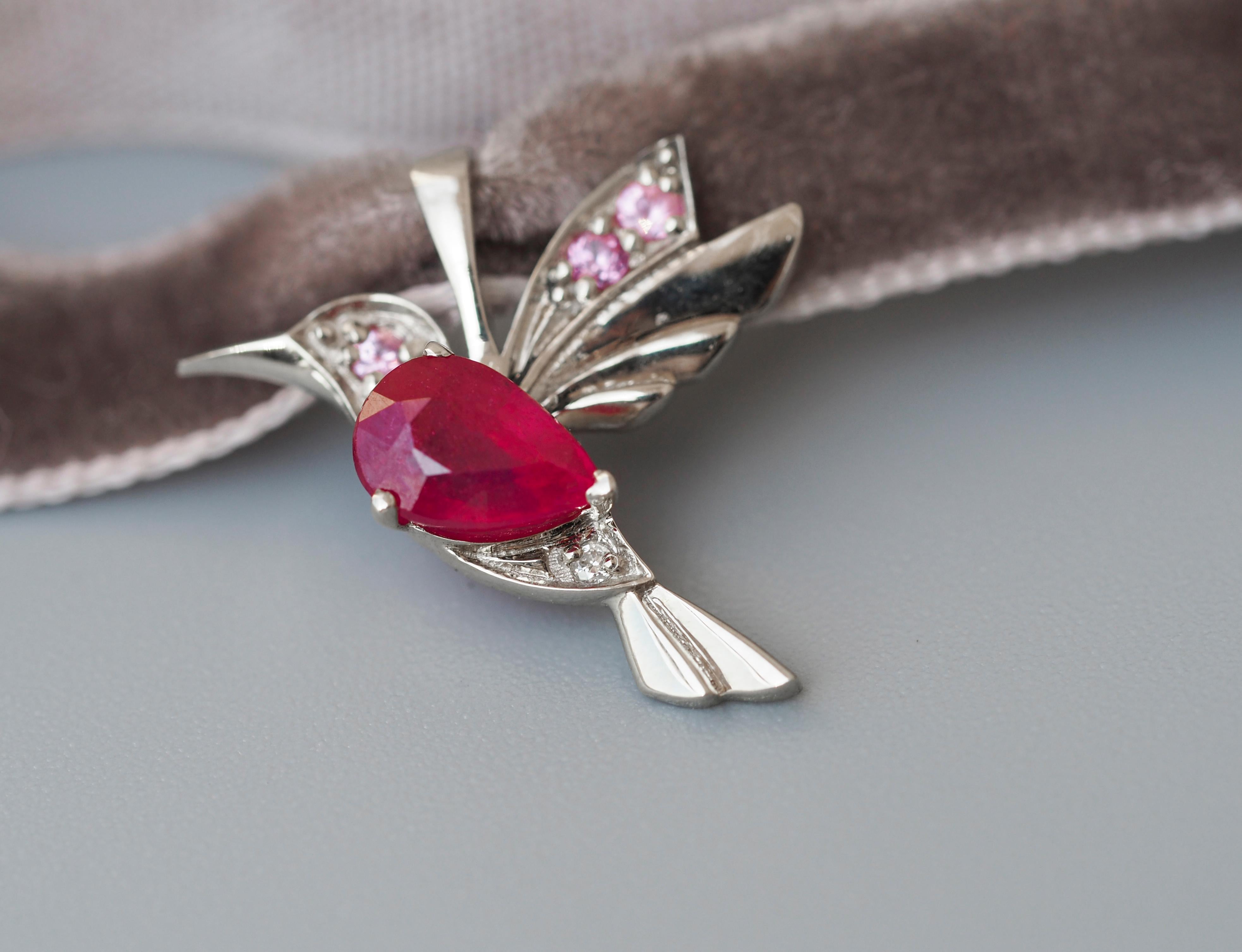 Hummingbird pendant with ruby. 
Pear ruby 14k gold pendant. July birthstone pendant. Gold bird pendant. Small bird pendant with gemstones.

Metal: 14k gold
Weight: 0.9 g.
Size: 12x16.6mm.

Set with ruby, color - red
Pear cut, 0.7 ct. in total (6x4